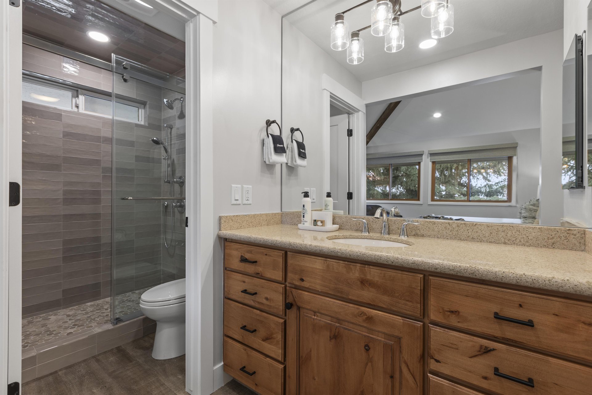 The en suite bathroom offers a single sink vanity and a separate water closet.