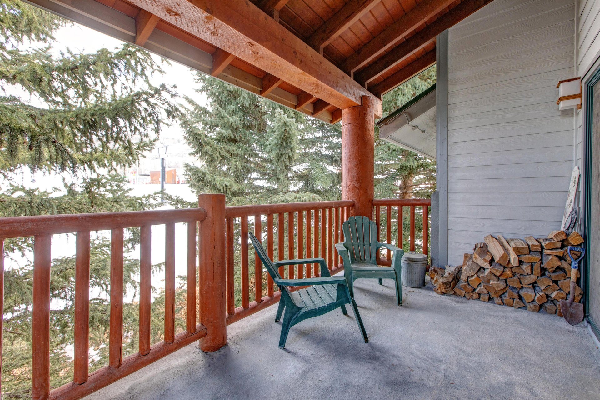 The private deck offers views of the evergreen trees and Park City Mountain Resort.