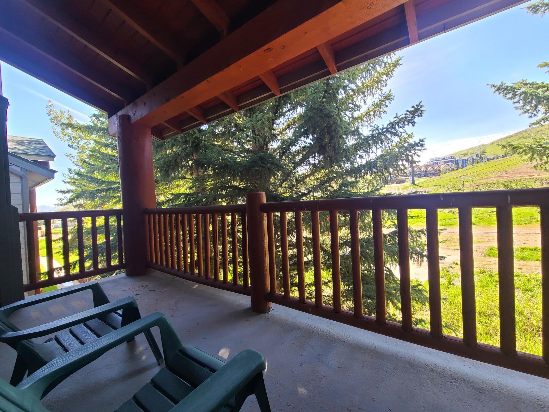 The private deck offers views of the evergreen trees and Park City Mountain Resort.