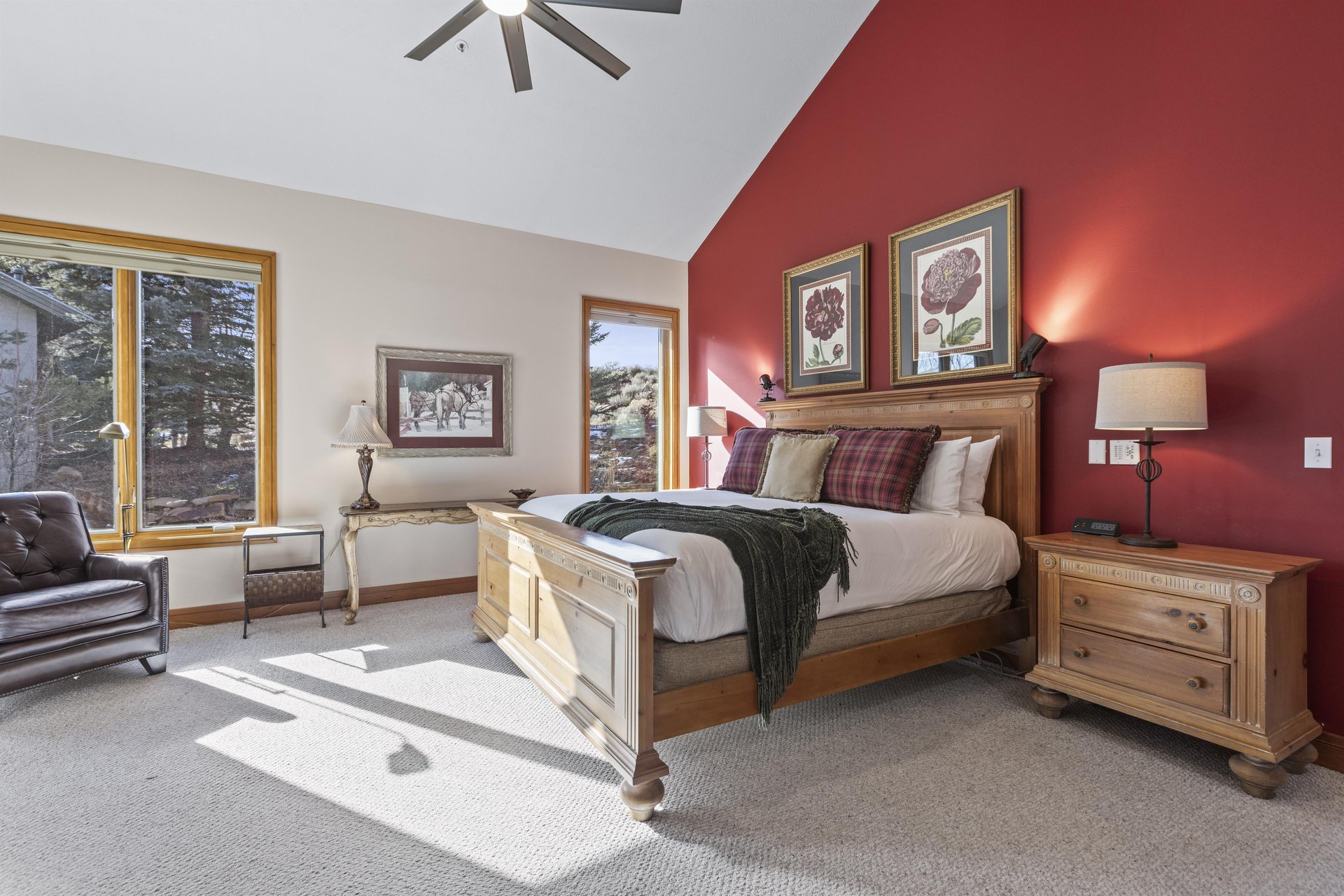 The spacious main suite with a kingsize bed and red accent wall.