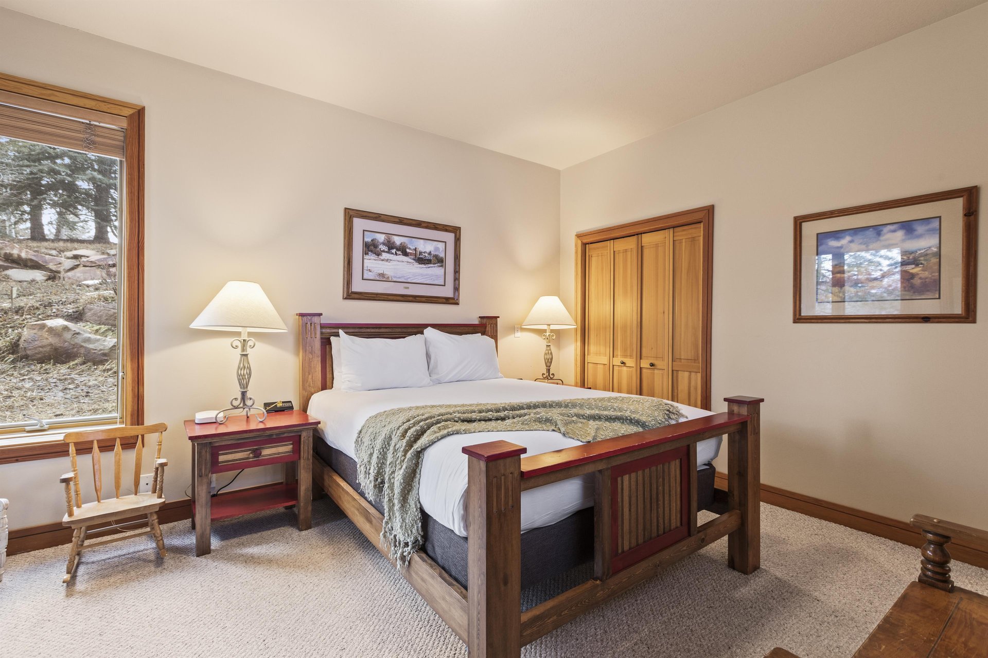 Another bedroom ahs a queen size bed and well appointed furniture.