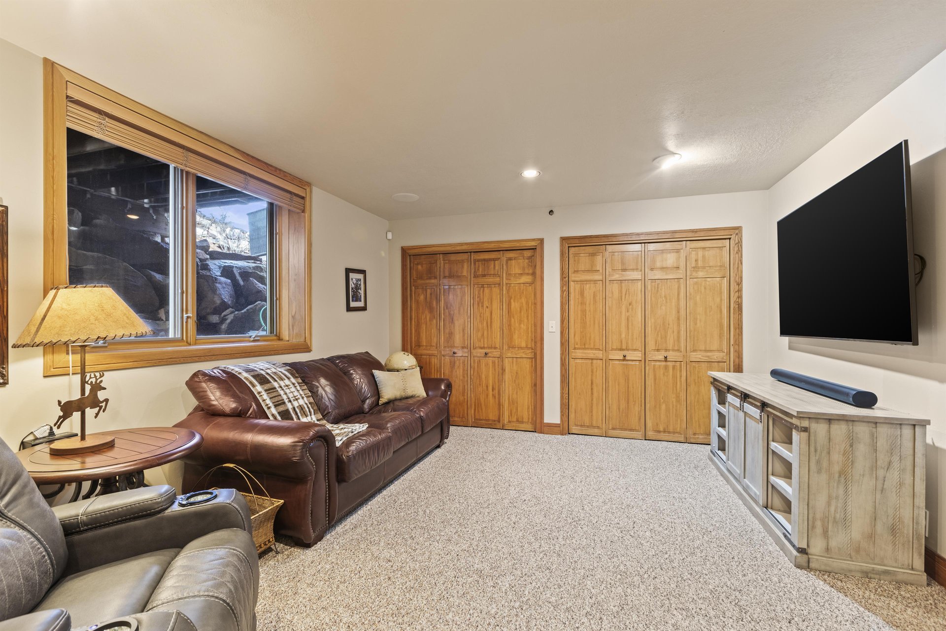 A second living area on the lower level has comfortable seating and a flat screen TV.