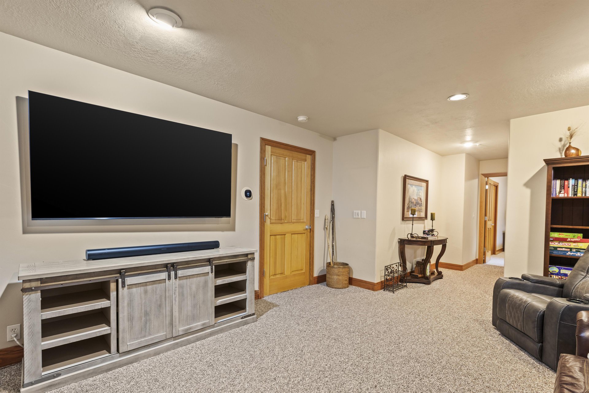 A second living area on the lower level has comfortable seating and a flat screen TV.