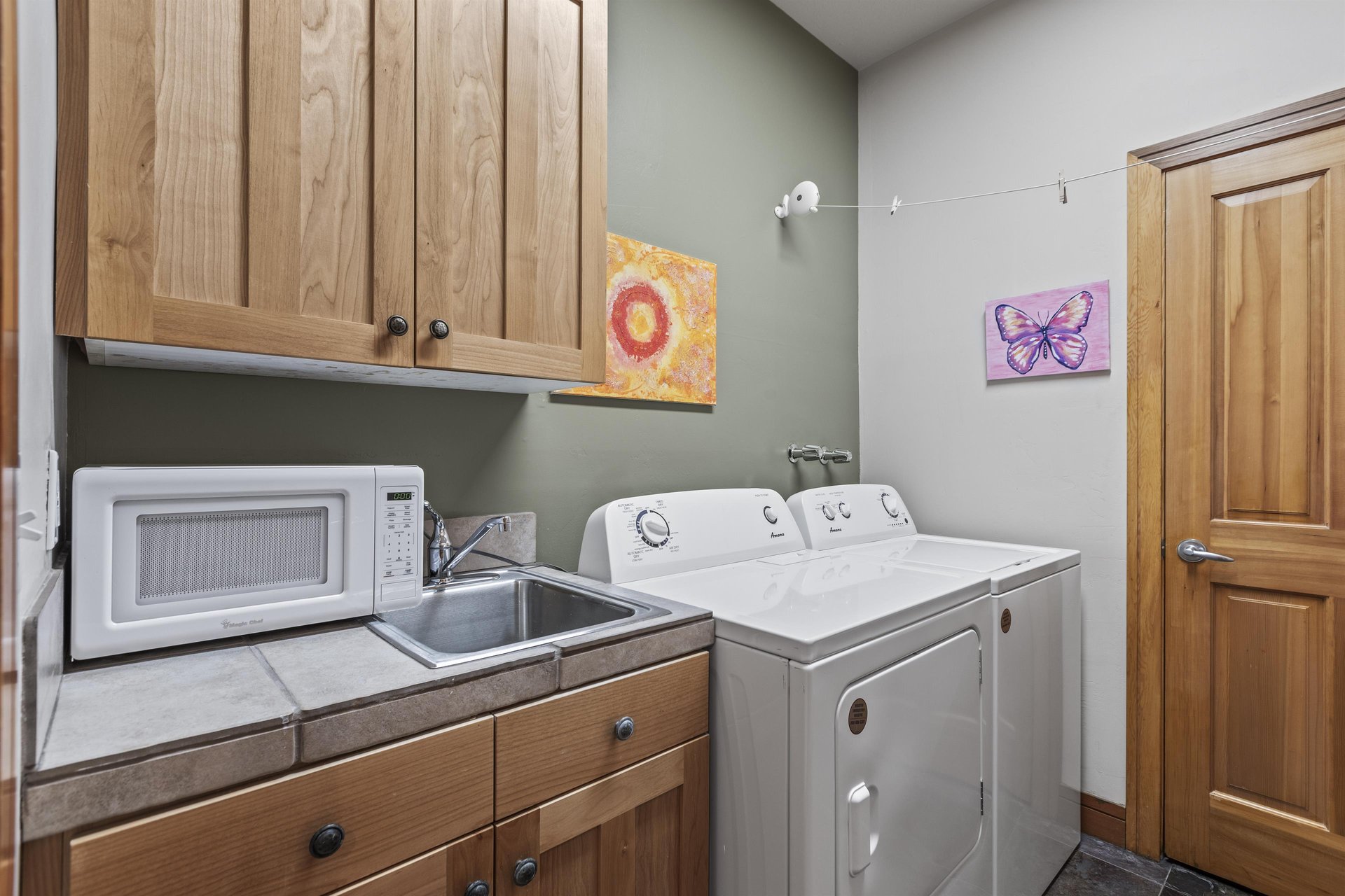 The laundry room has a private washer and dryer and utility sink.