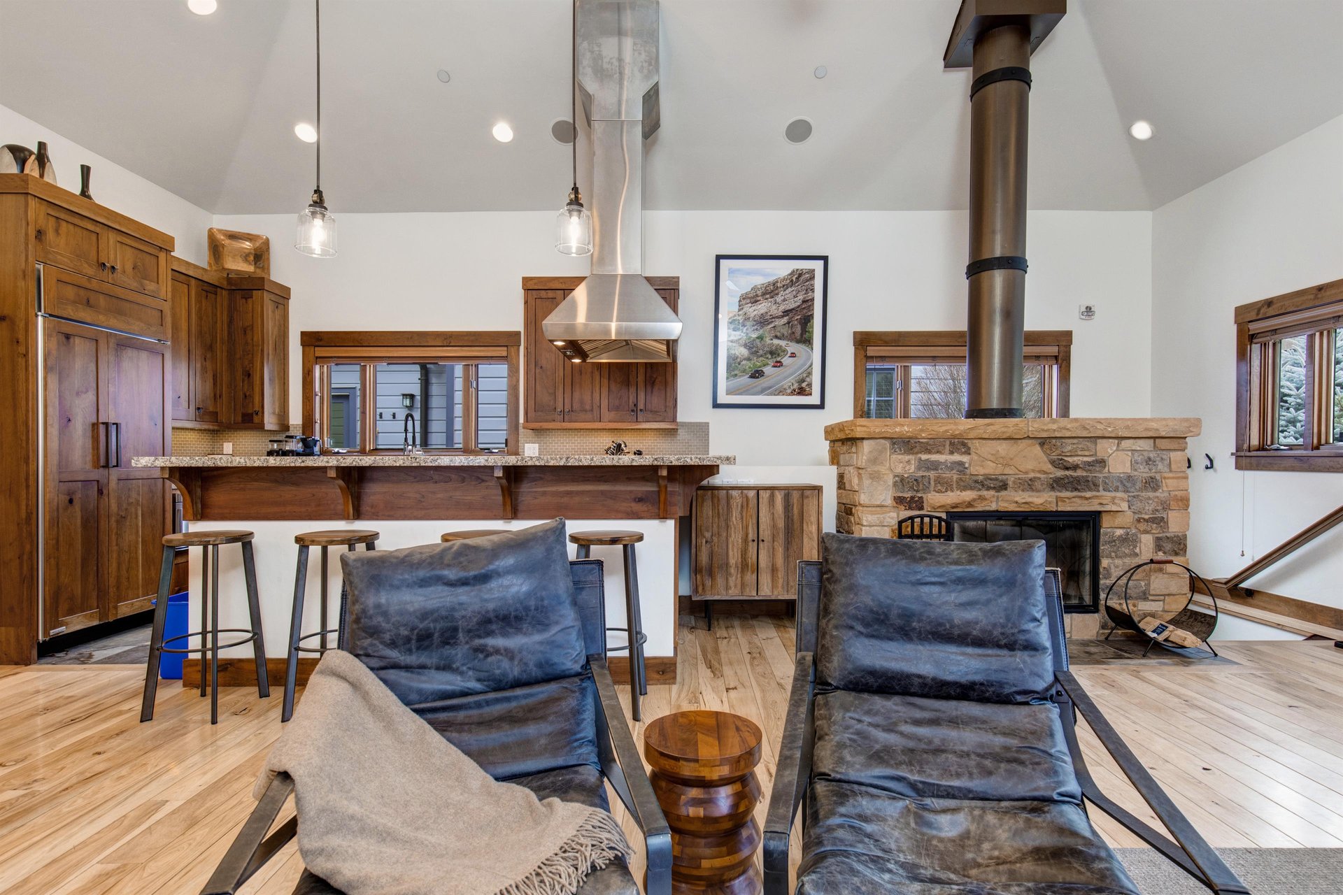 Two comfortable leather chairs in the open concept living area.