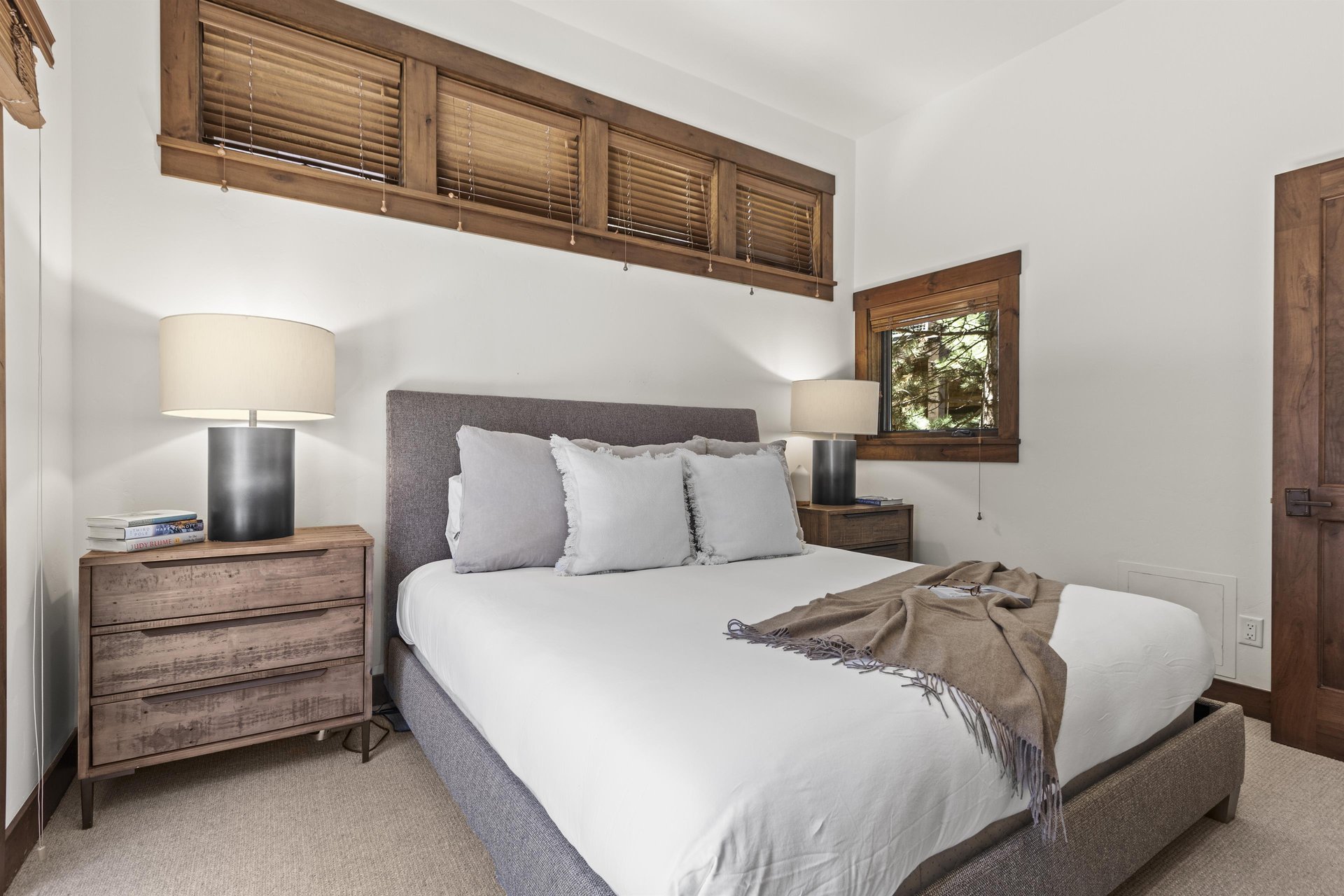 Town Lift Chalets second bedroom with a luxurious king size bed and white linens, and well appointed furnishings.