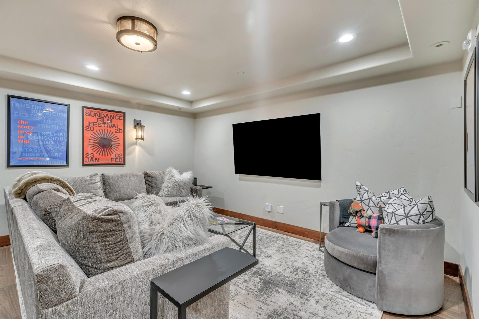 Relaxing den area with entertainment center featuring a 75 flat screen TV