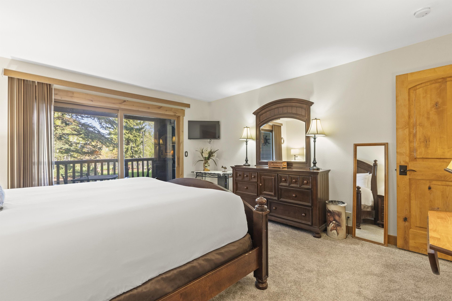 The main suite offers a king size bed and sliding glass doors to a private patio.