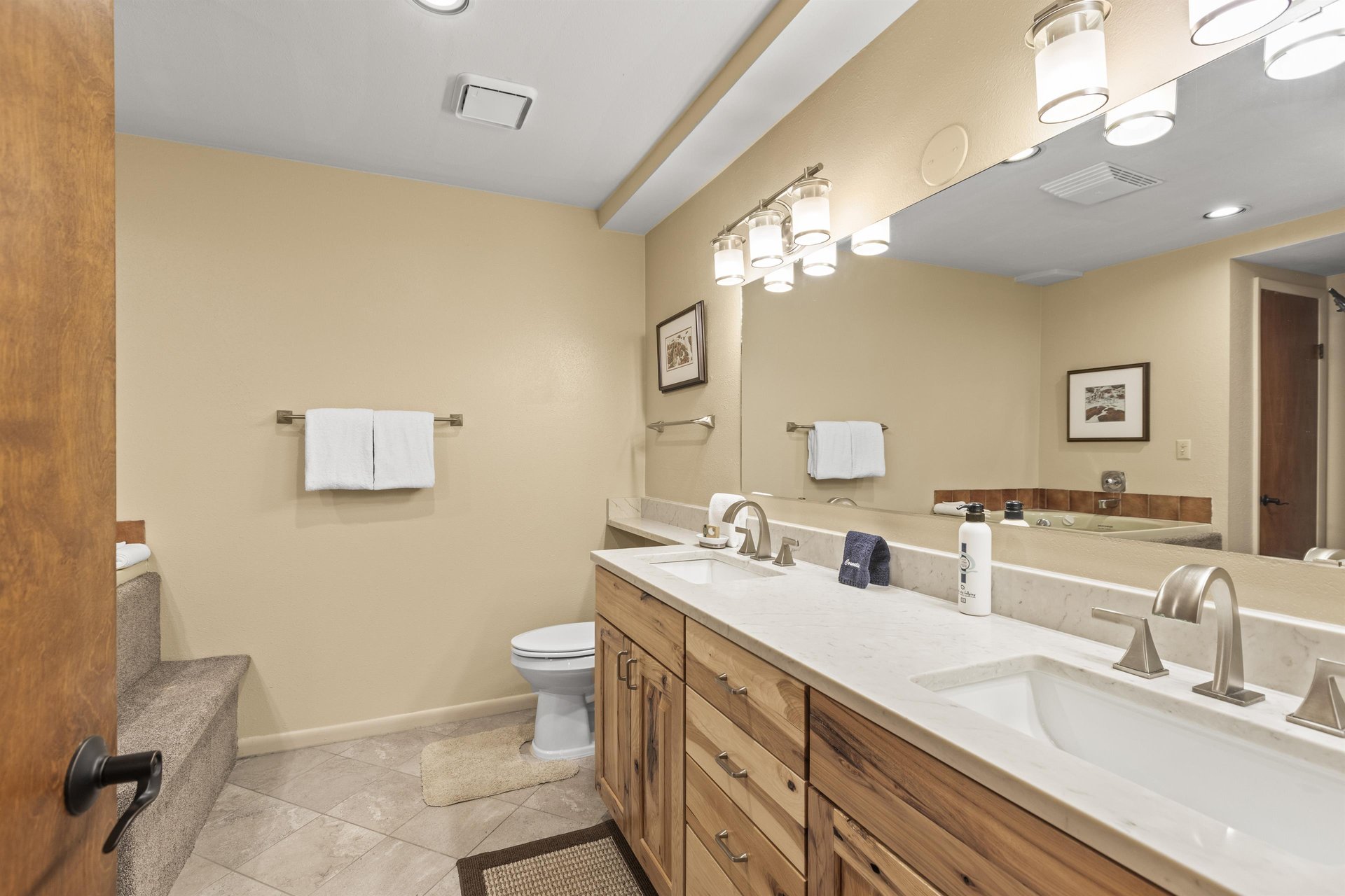 The en suite bathroom has a double sink vanity