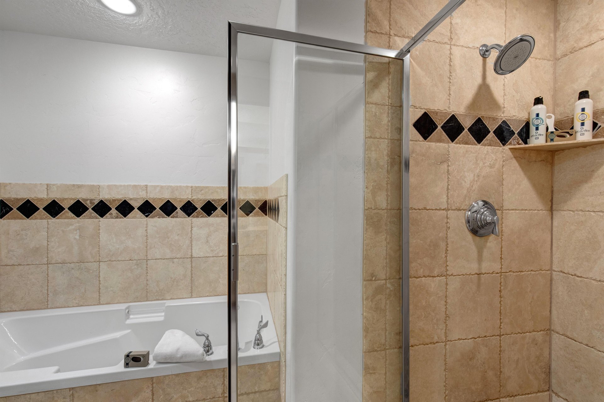 The en suite bathroom offers a deep soaker bathtub and walkin shower.