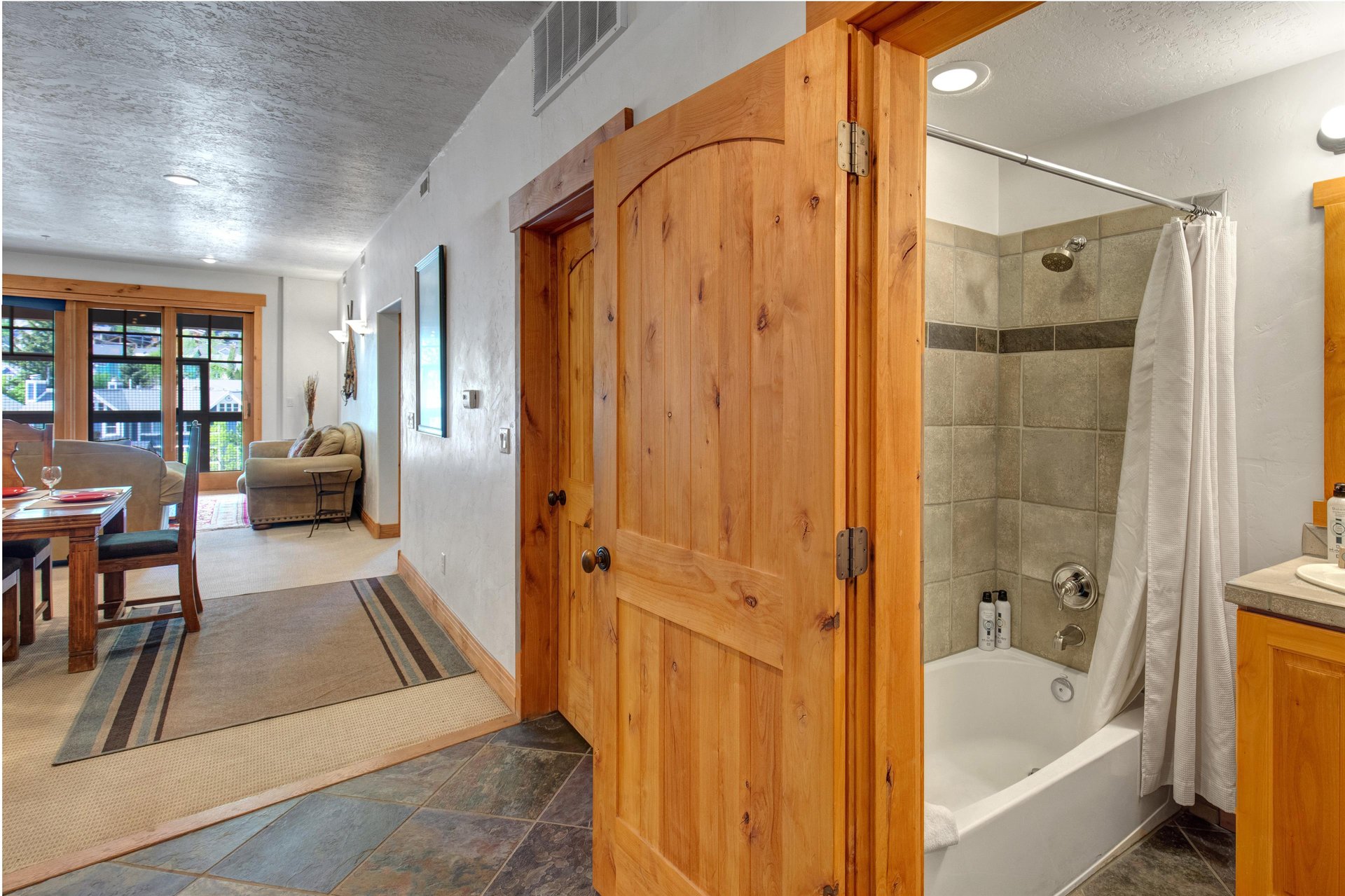 The shared bathroom with bathtub and shower combination.