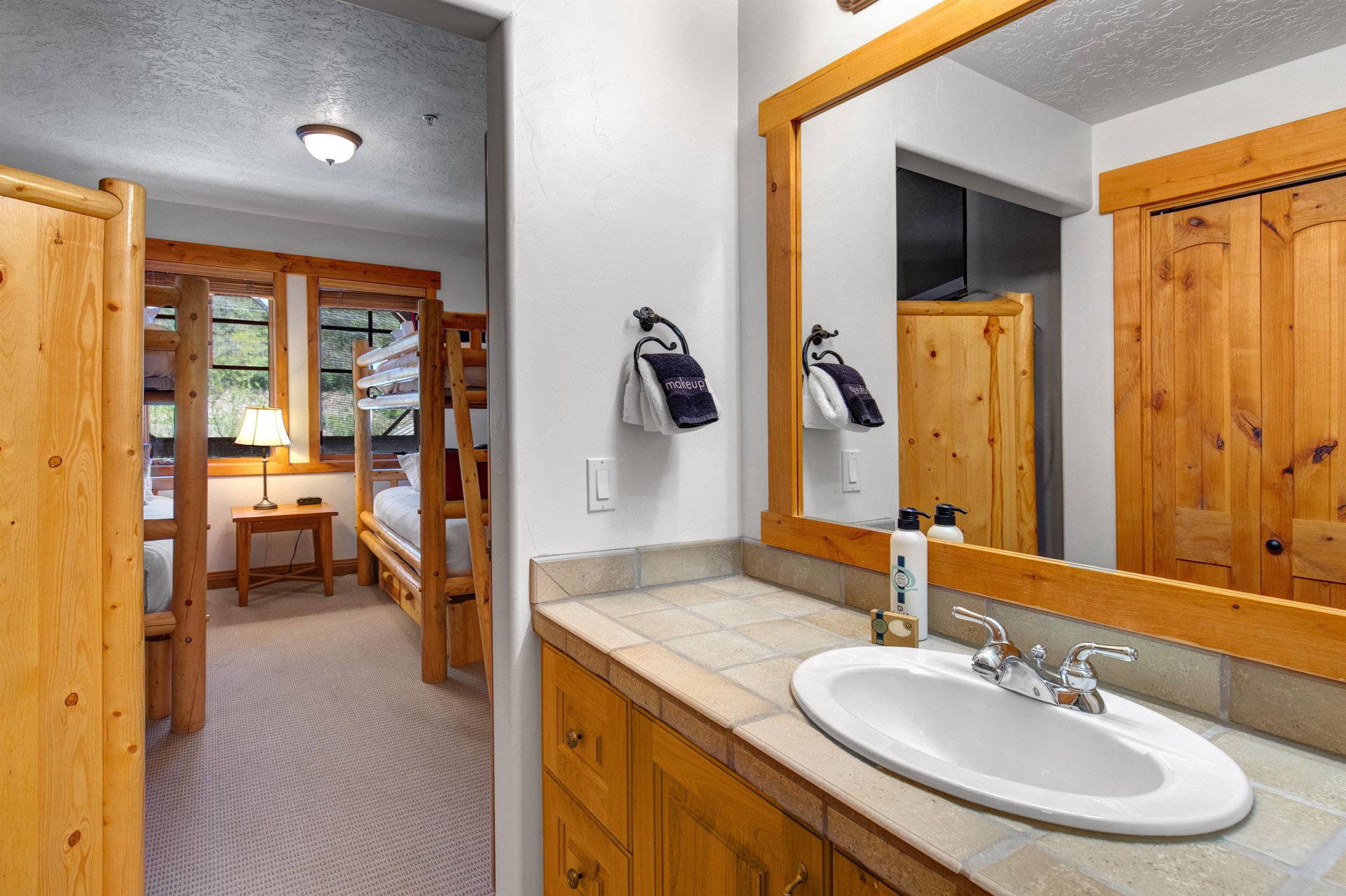 The en suite bathroom has a single sink vanity.