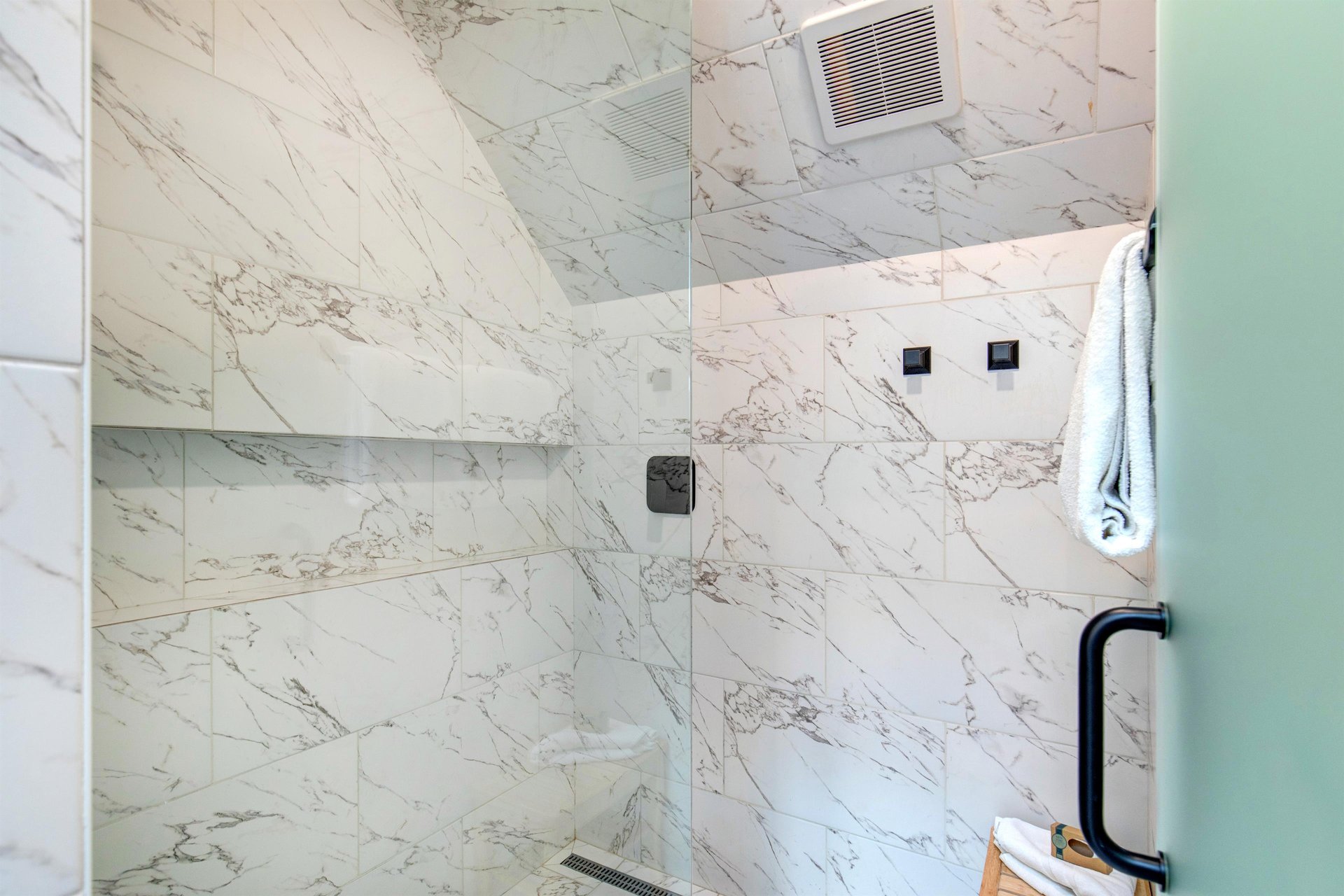 The walk in shower with European glass door.