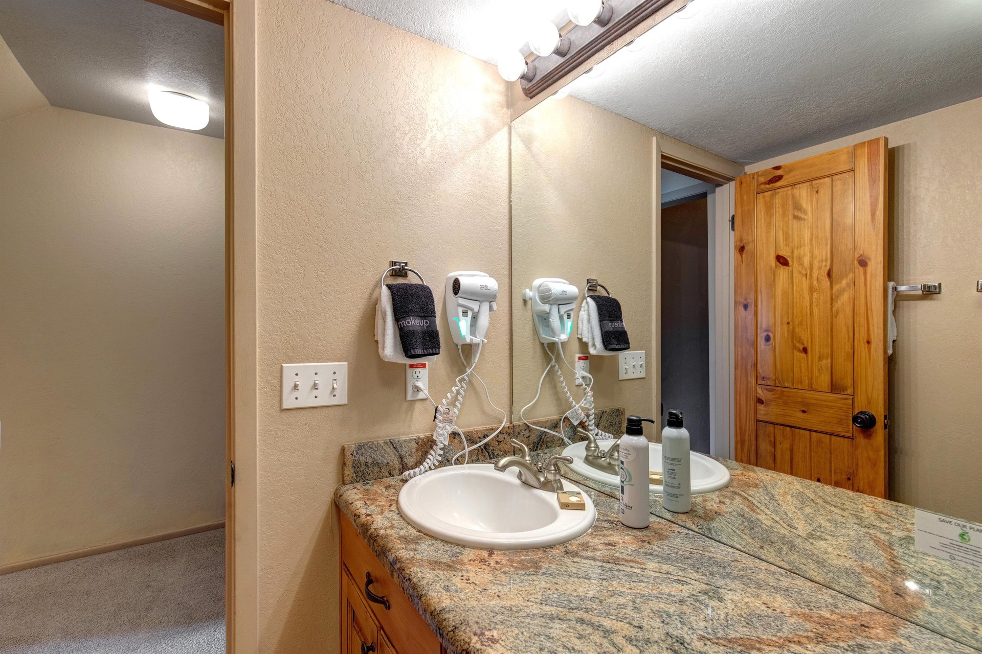 The bathroom has a two sink vanity.