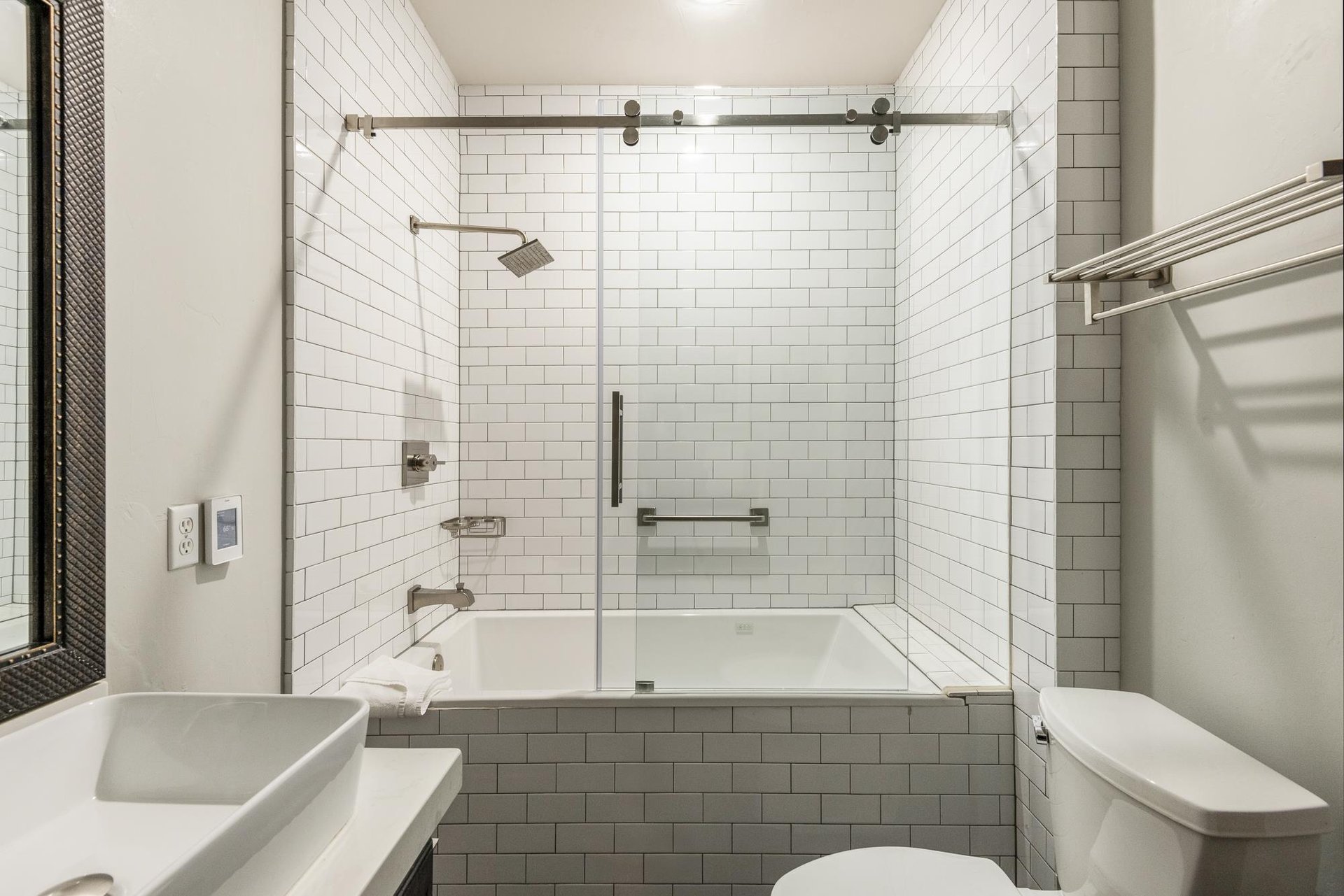 The shared bathroom with bathtub and shower combination.