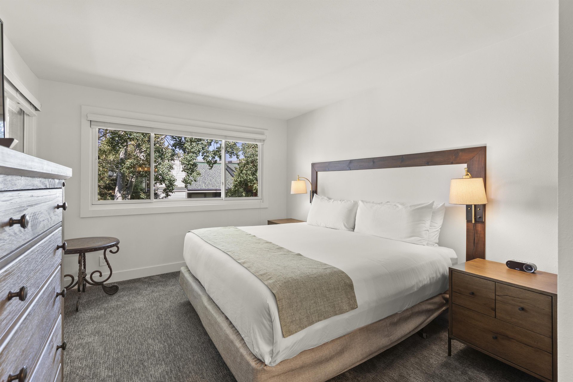 The main suite bathroom has a king size bed and large window.