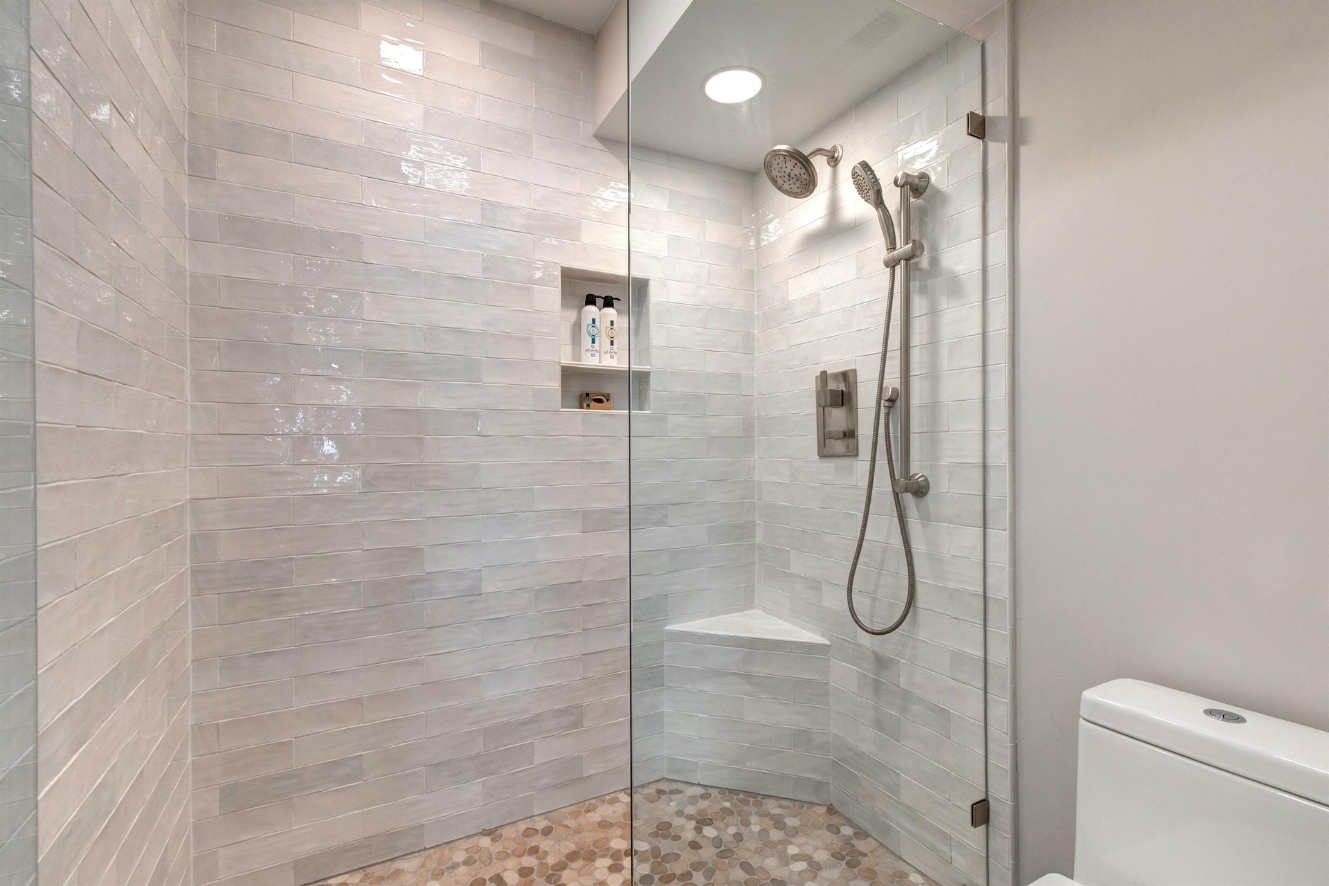 The en suite bathroom has a walkin shower with European glass door.
