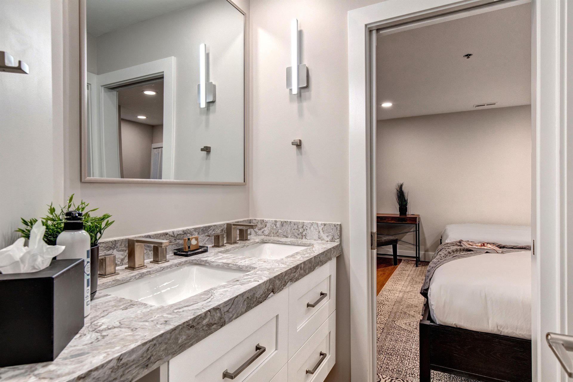 The shared bathroom offers a double sink vanity.
