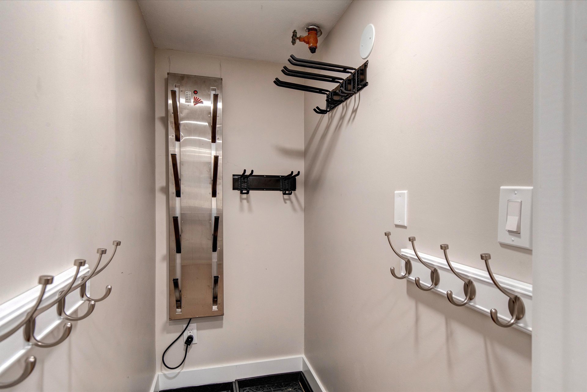 The storage room with plenty of hooks for gear, clothes and boots.