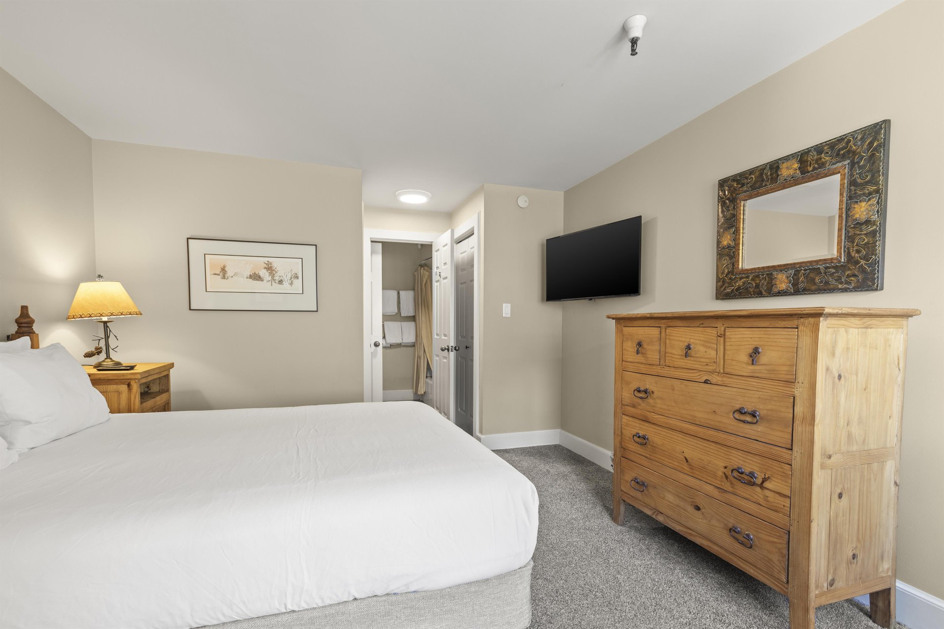 The main suite with a queen size bed and wellappointed furniture.