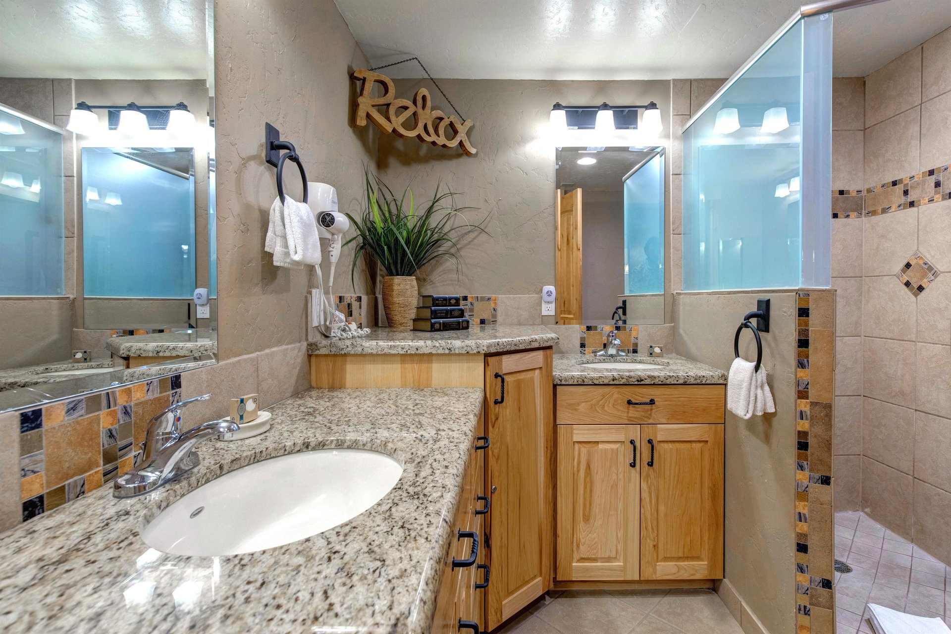 The spacious shared bathroom with 2 sink vanity.