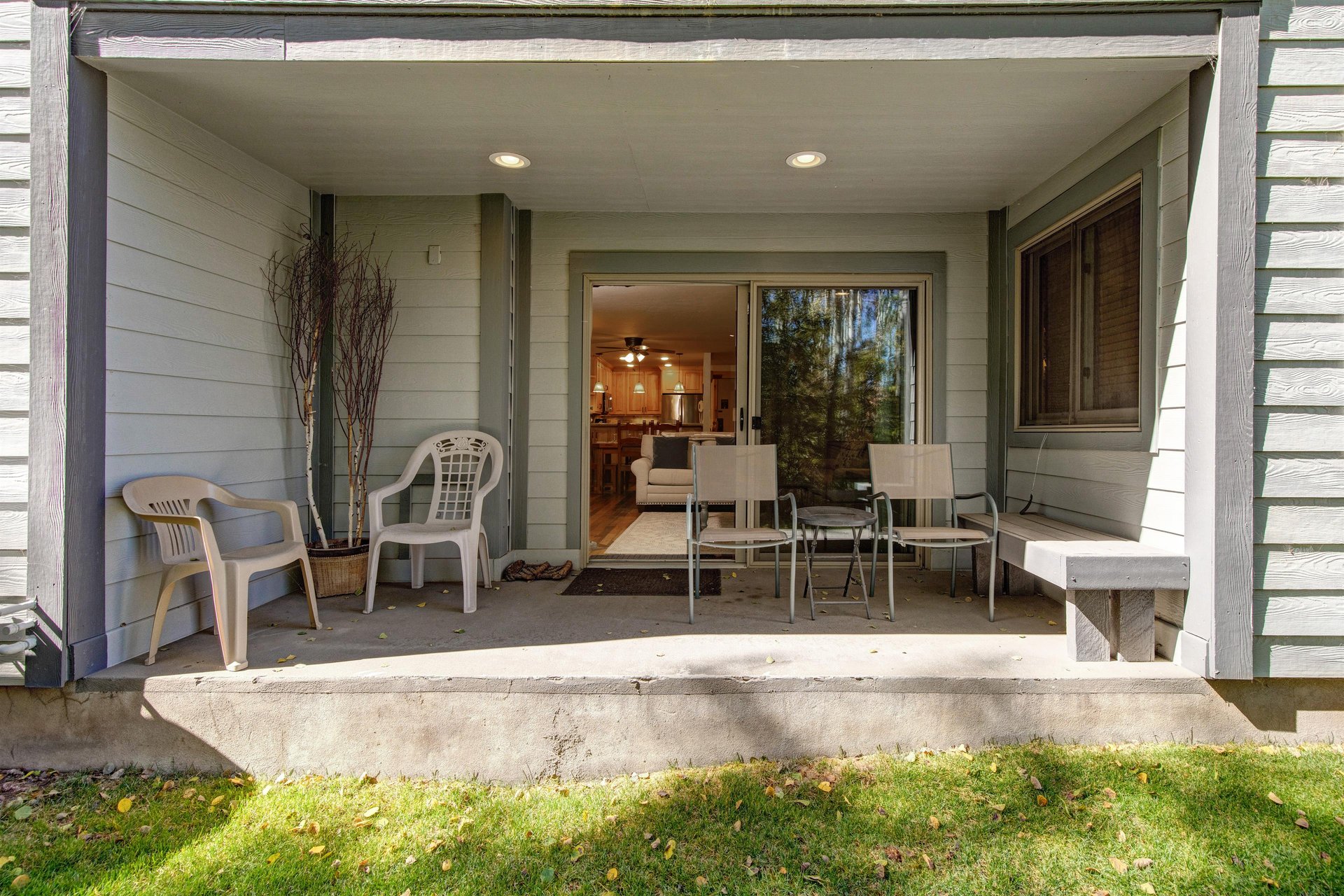 The private patio with 4 chairs and a bench.