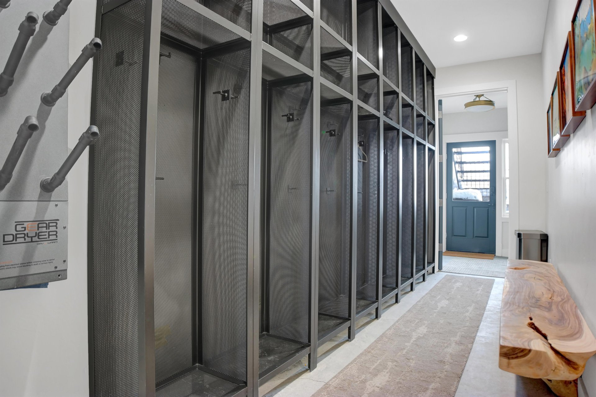The lower level entrance leads an entry with plentiful floor to ceiling ski lockers that line the wall and boot dryers.