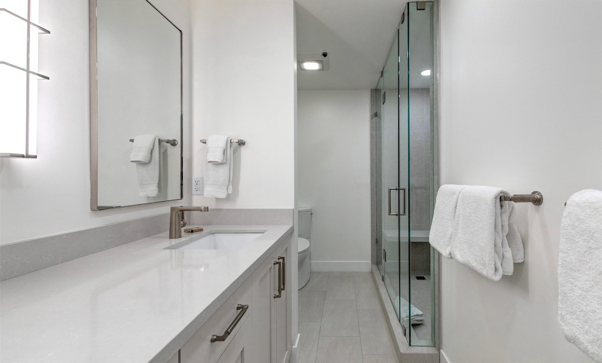 The en suite bathroom with two sink vanity and walkin shower.