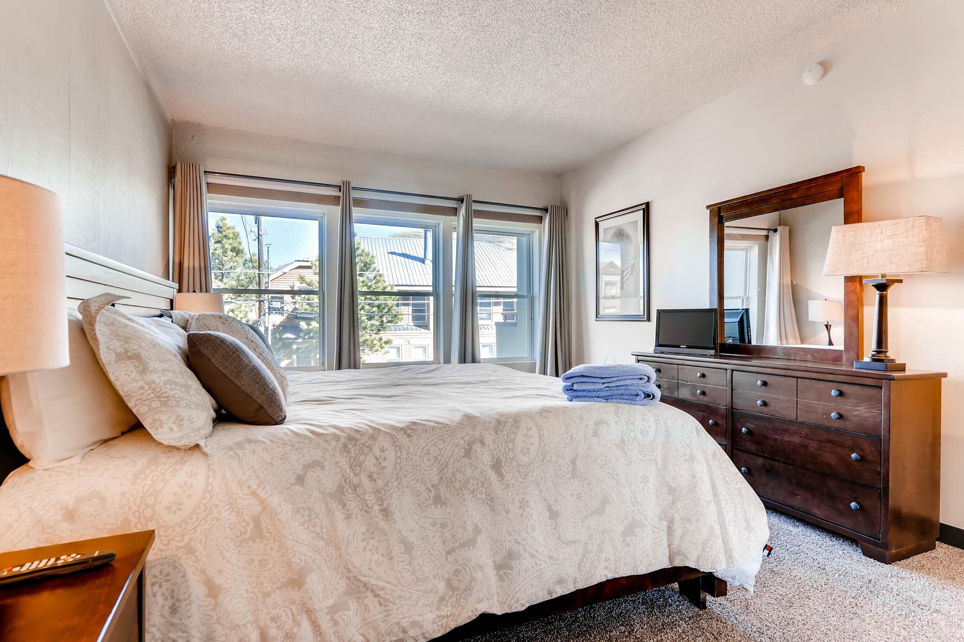 One bedroom has a kingsize bed and large windows.