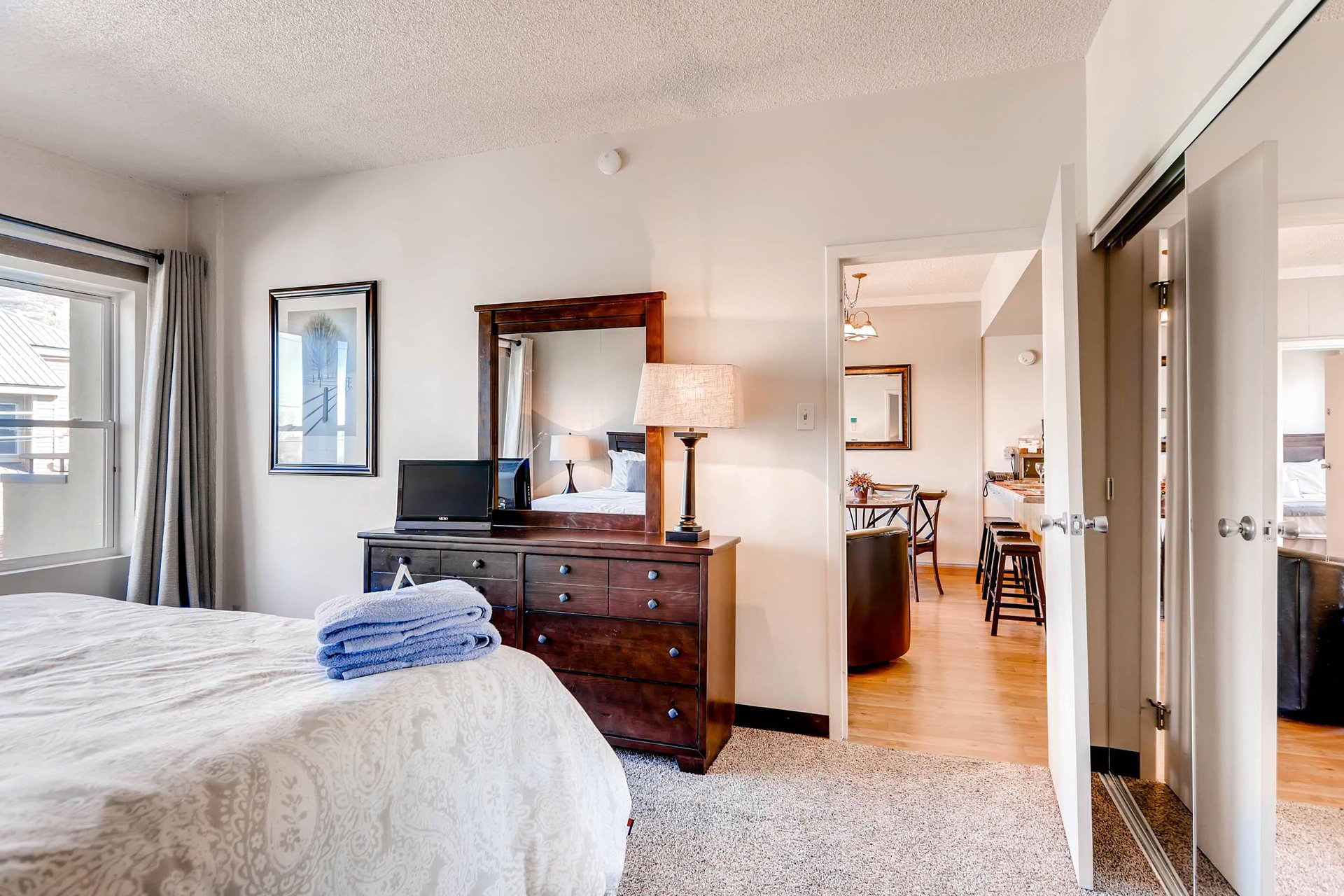 One bedroom has a kingsize bed and large windows.