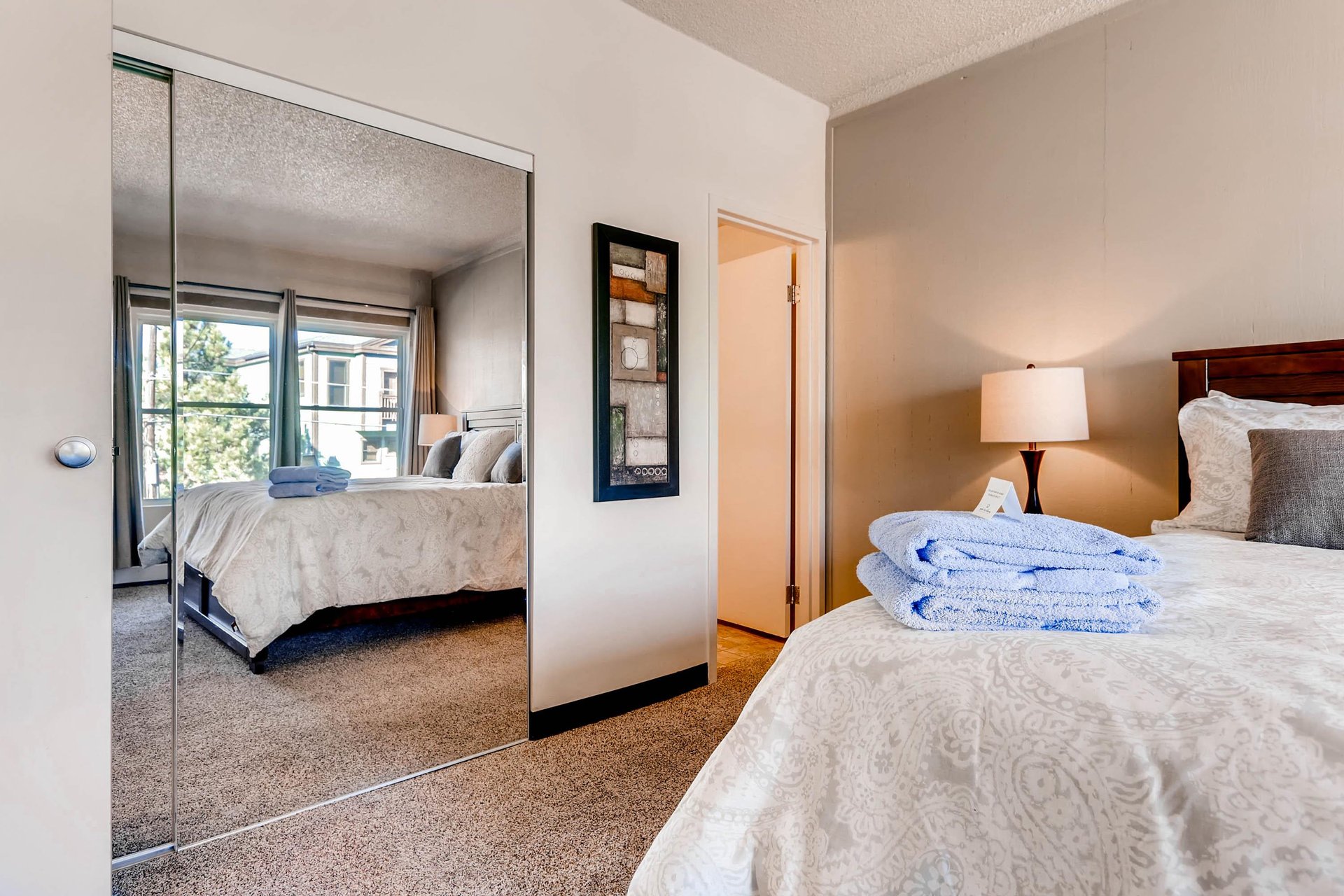 One bedroom has a kingsize bed and large windows.