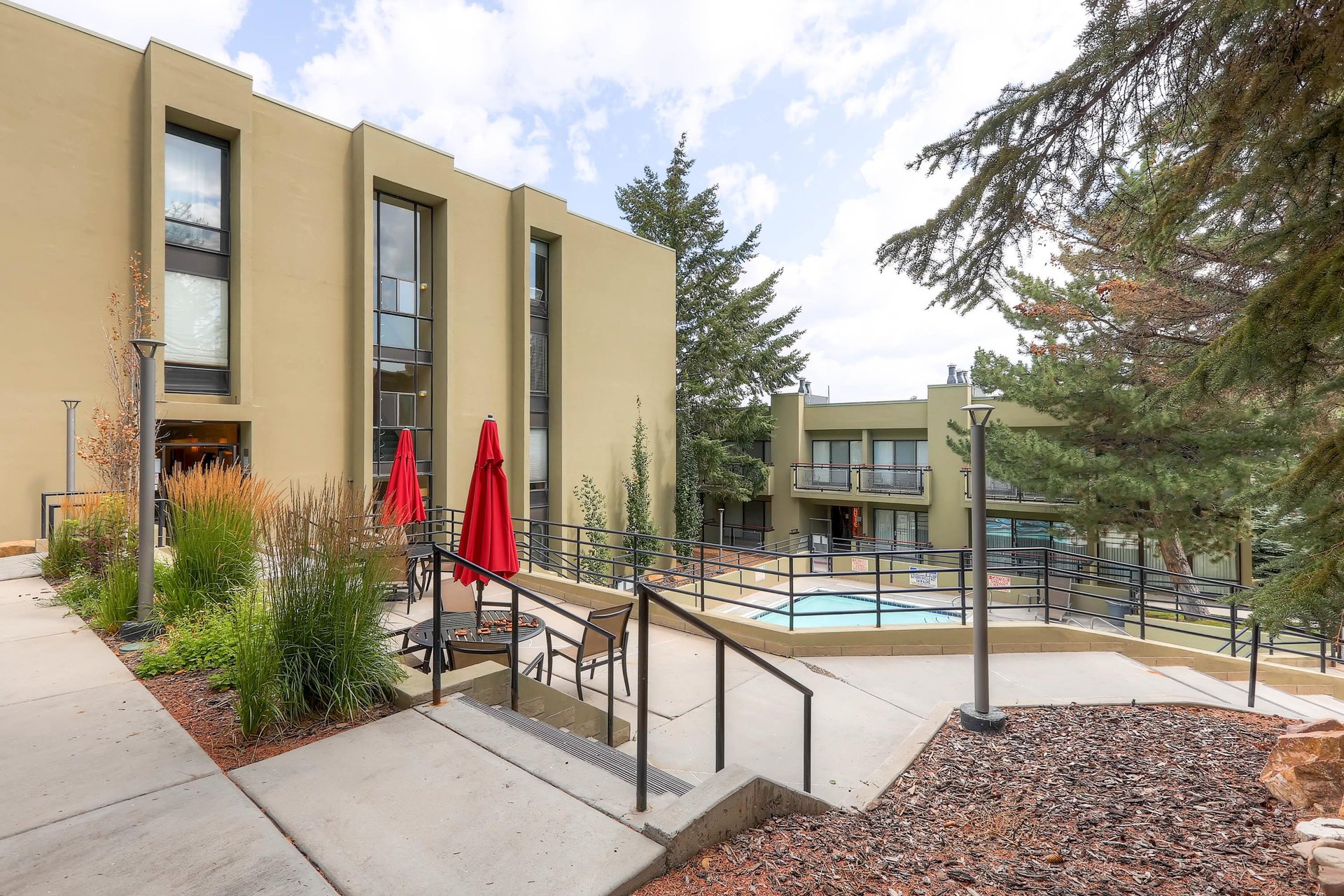 Edelweiss Condos offers a community pool and outside sitting area.