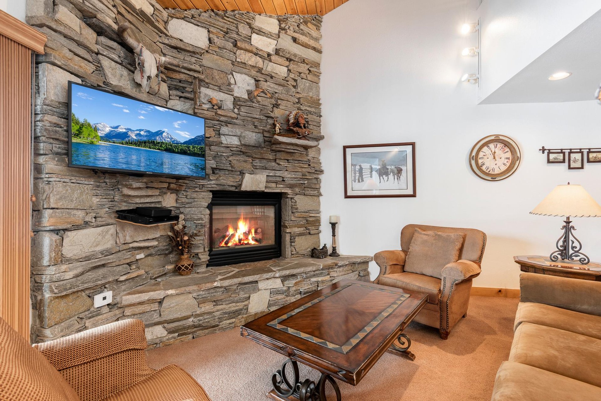 Beautiful stone fireplace, flat screen TV and cozy furnishings.