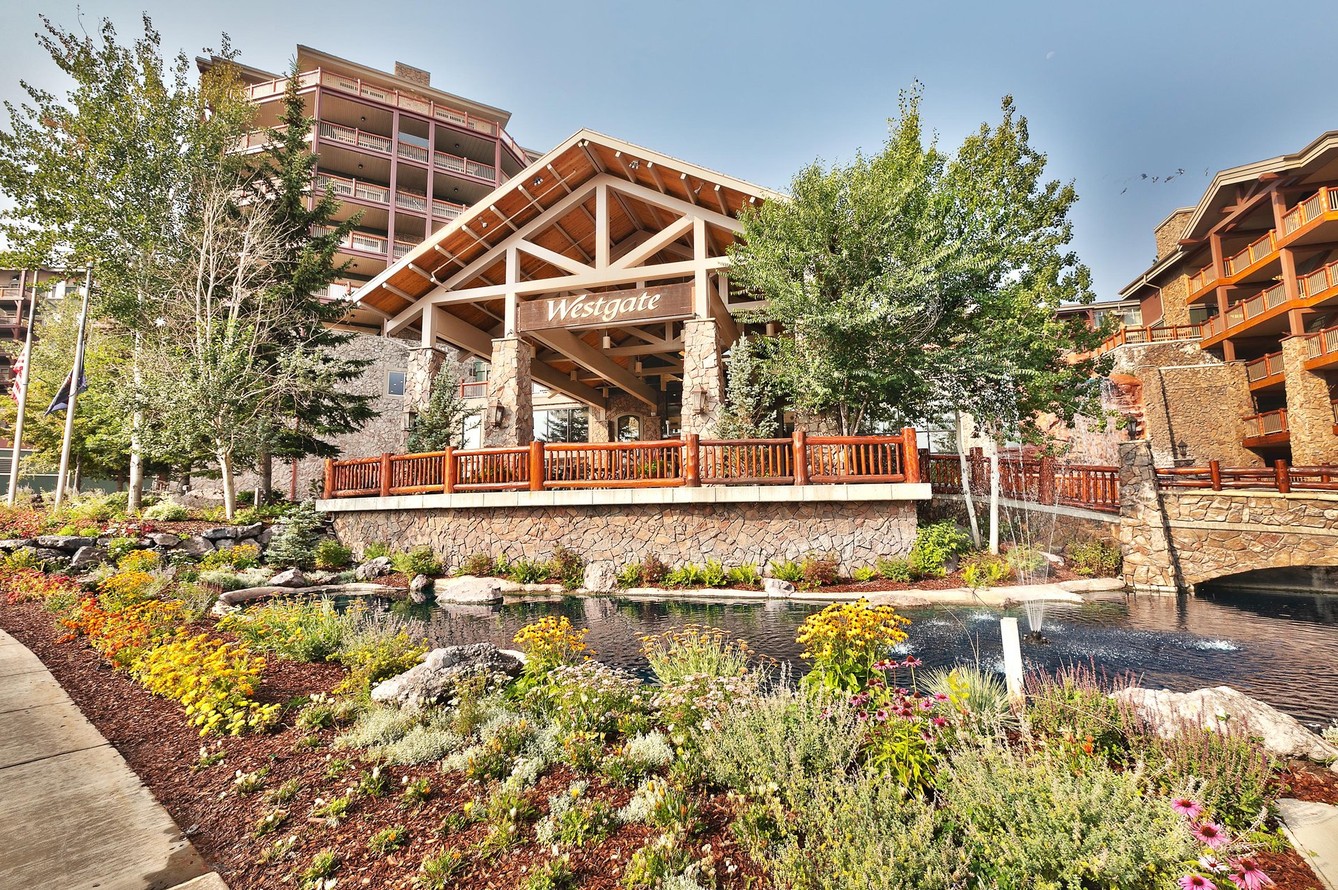 Westgate Park City exterior with water feature and wildflowers