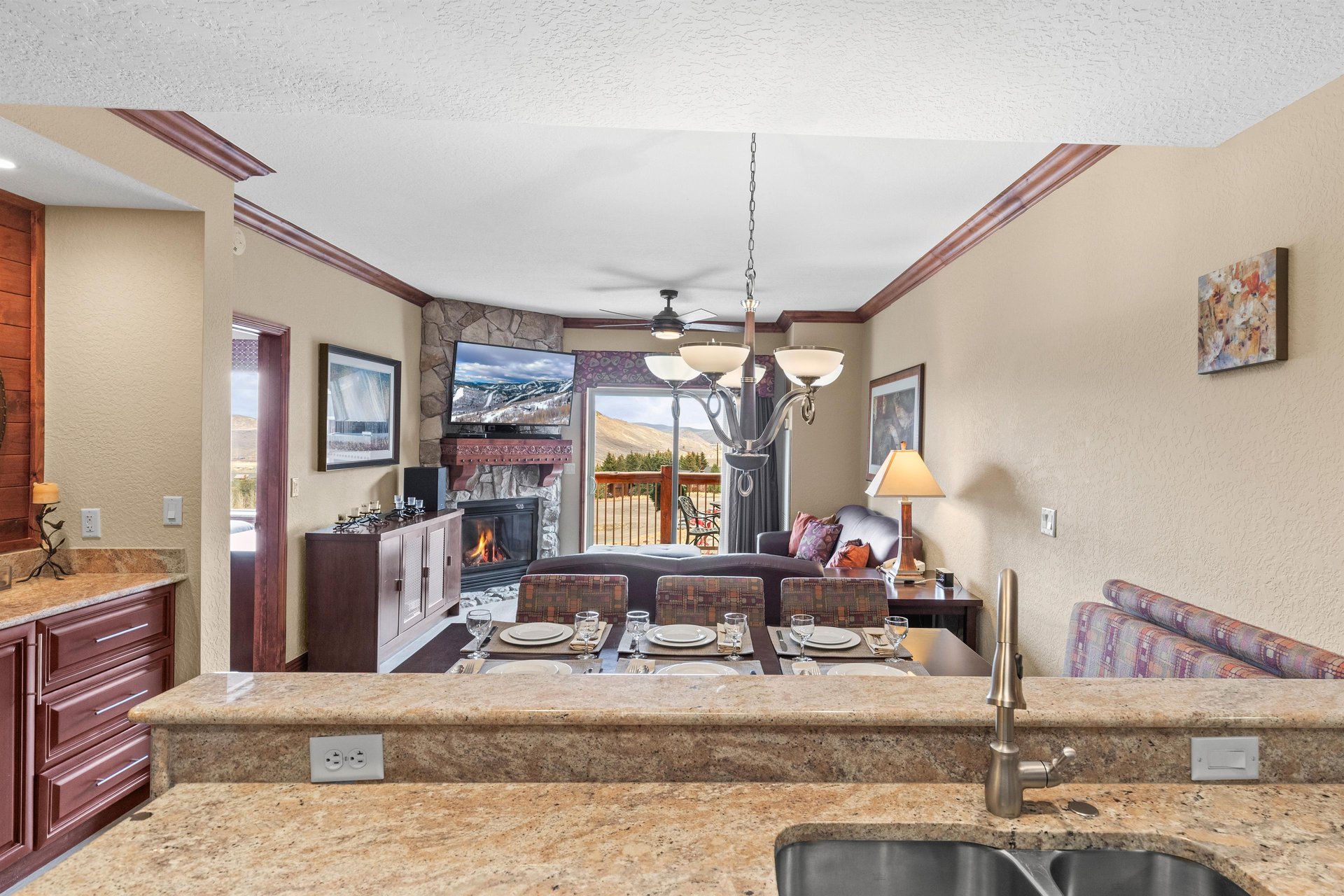 Gather around your elegant dining table while the fireplace creates a cozy ambiance.