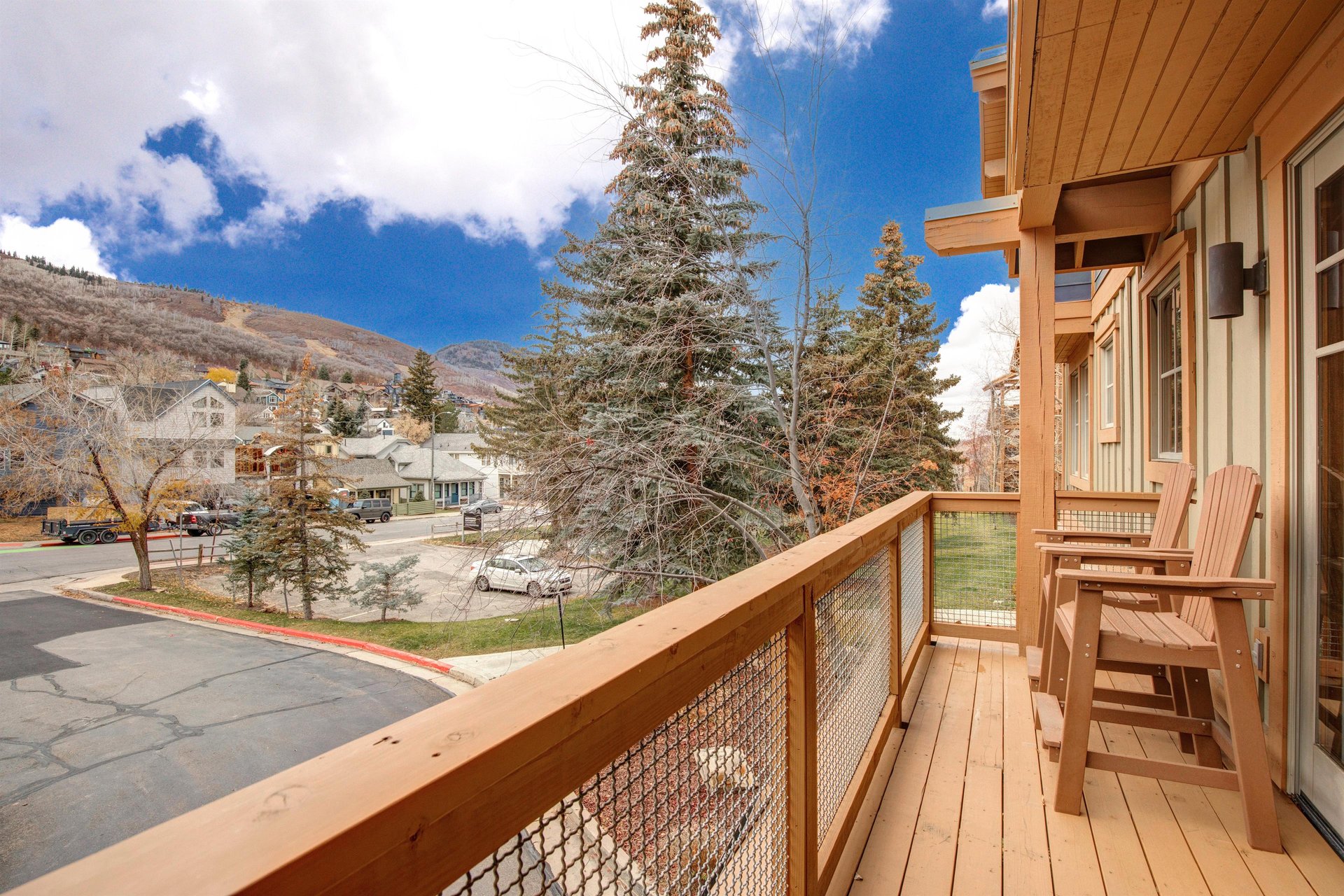 Relax on your private wooden balcony with comfortable seating and take in the mountain views.