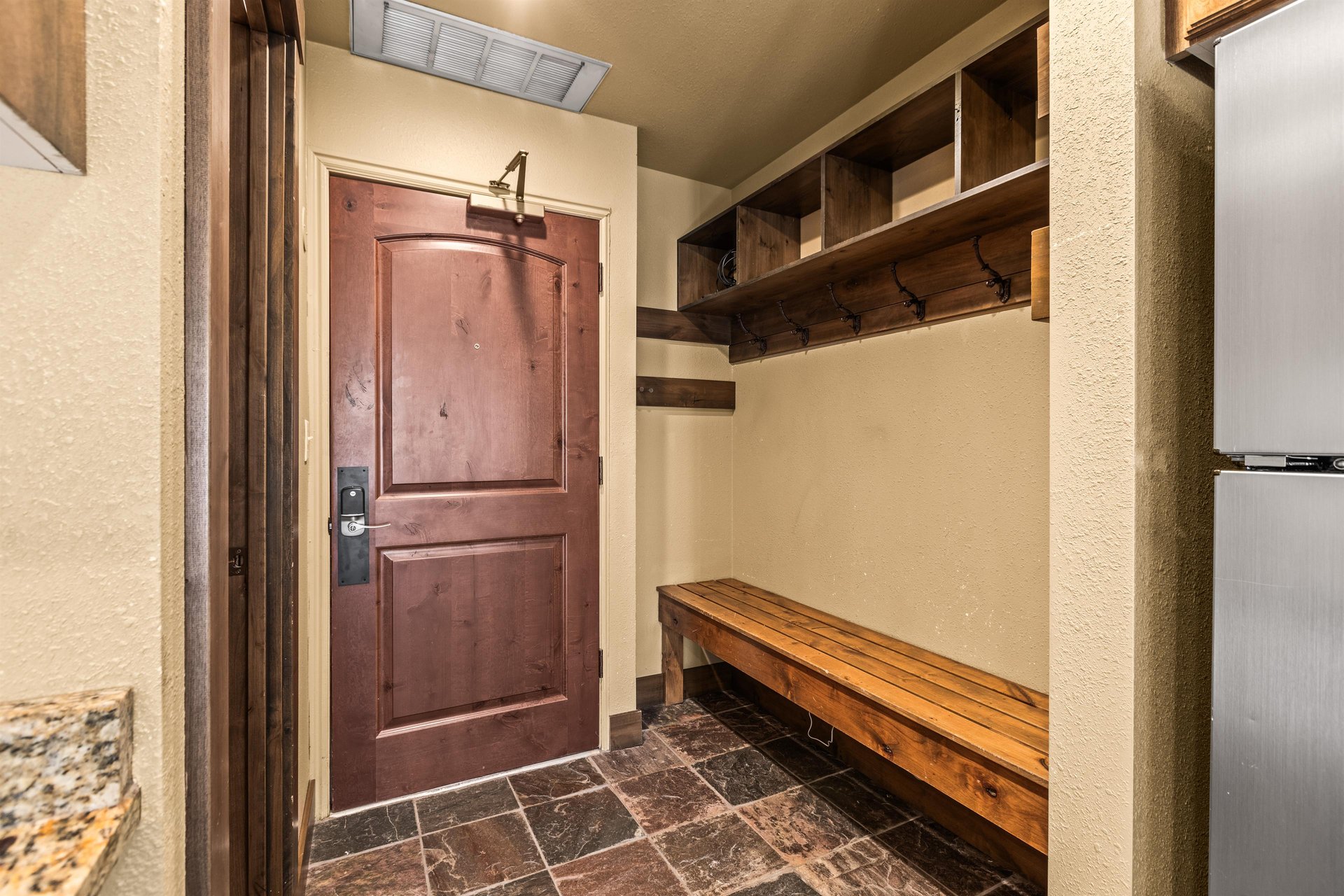 The entryway with a large bench and plenty of space to put outdoor gear.