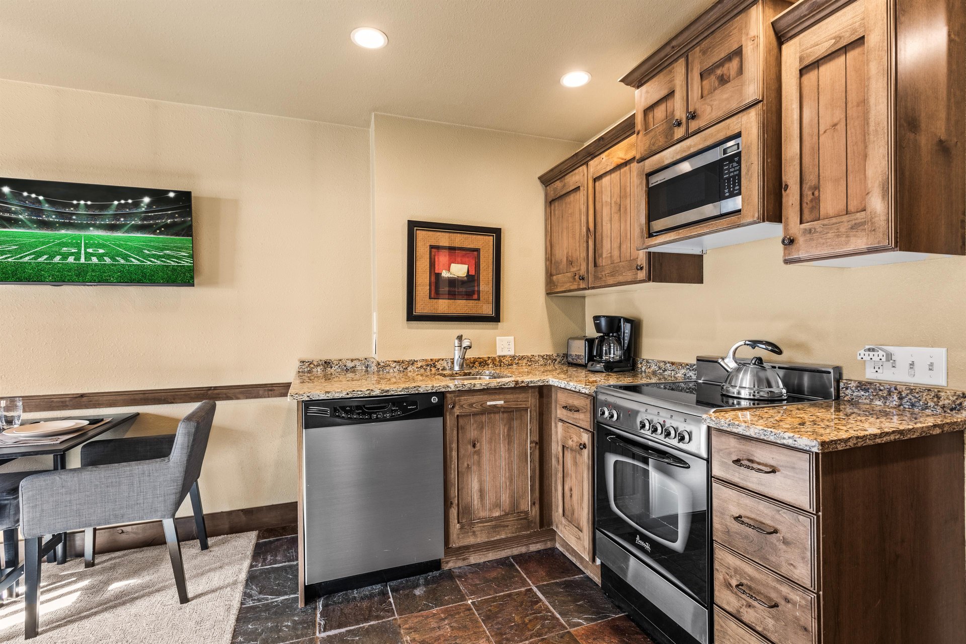 The efficient kitchen with oven, refrigerator, microwave, and dishwasher.