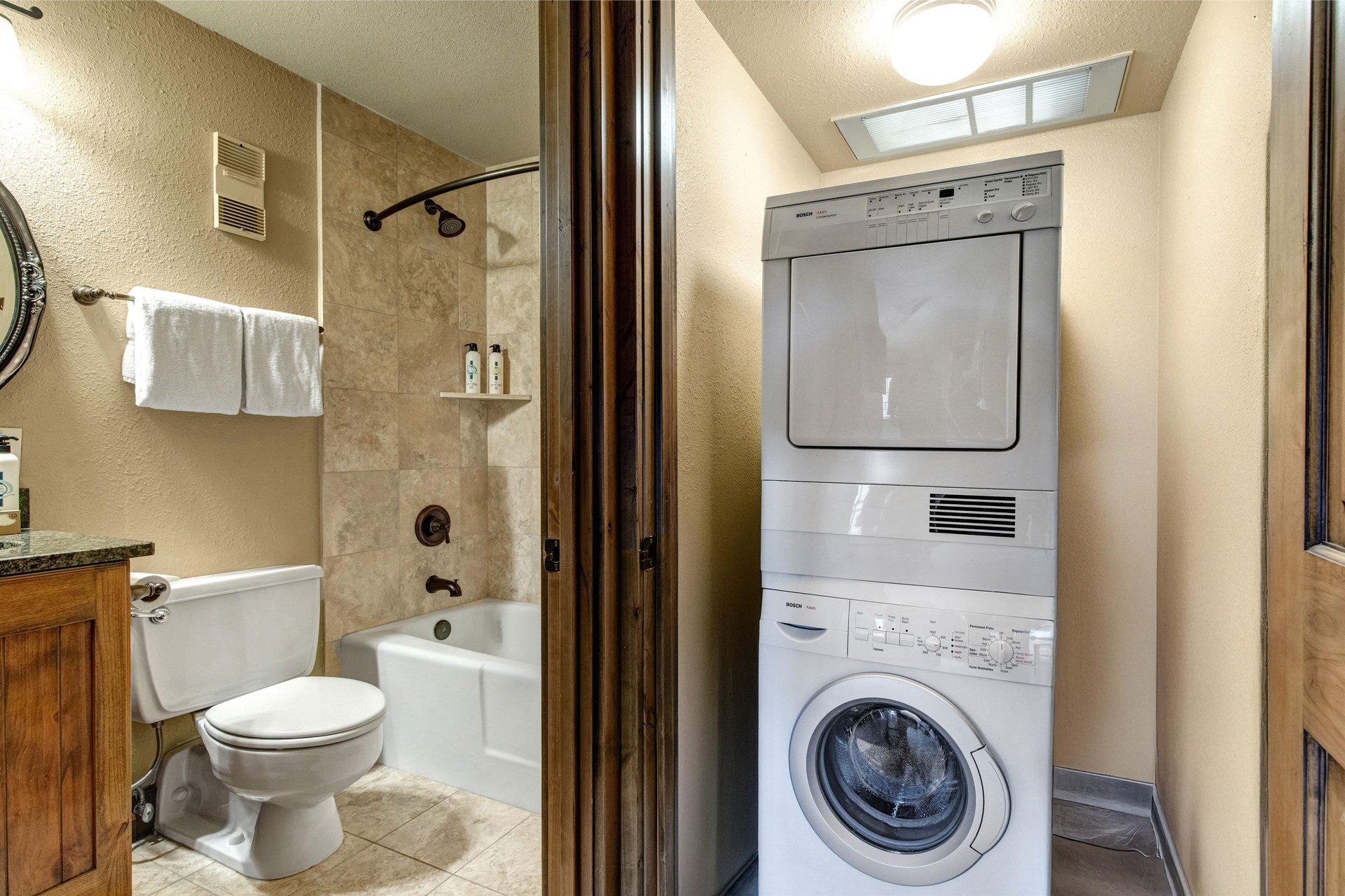 Your bathroom features a relaxing tubshower combo with warm stone tiles, while the convenient inunit washer and dryer keeps your clothes fresh throughout your stay.