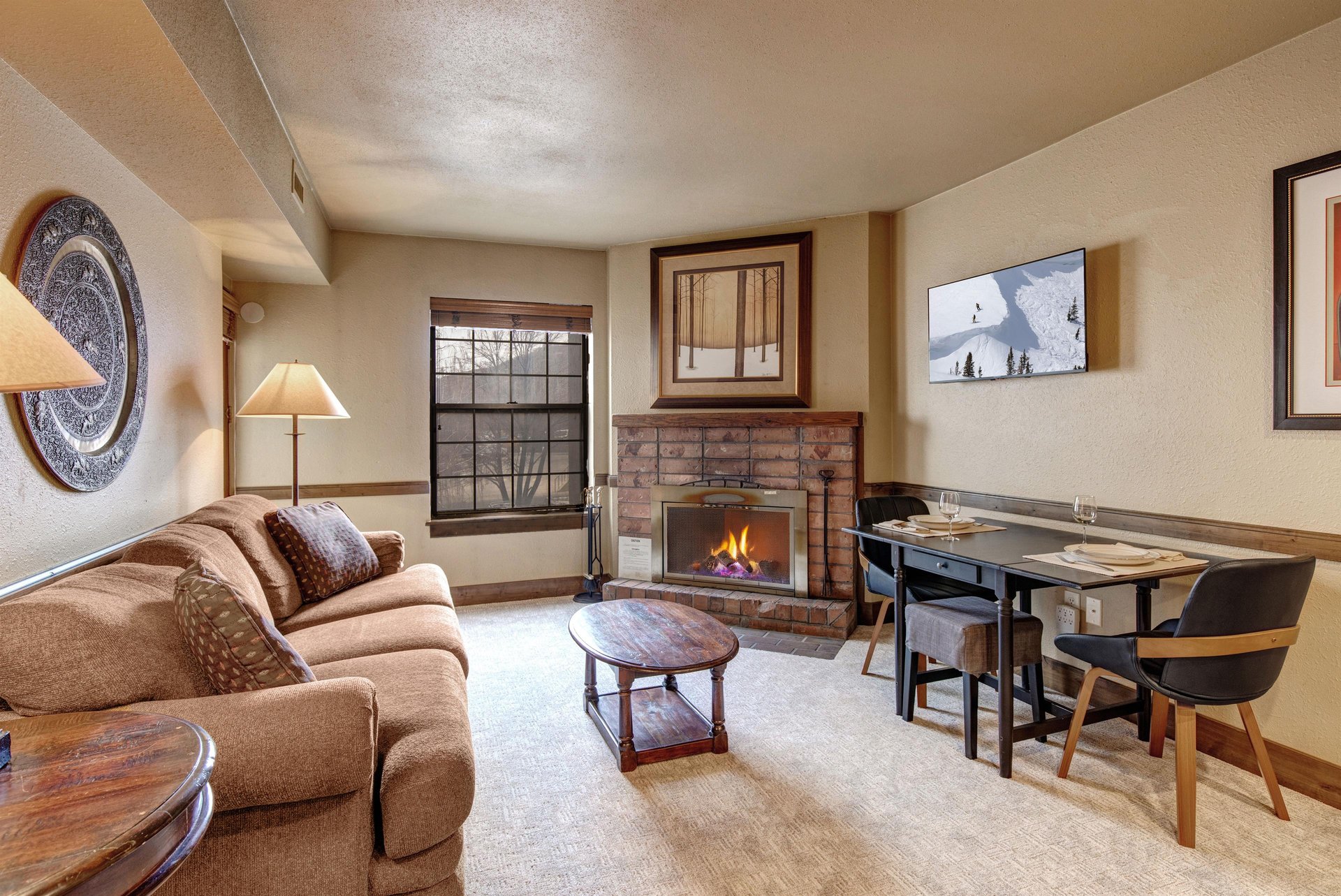 Cozy up in this charming living space where a crackling fireplace creates the perfect ambiance for your mountain getaway.