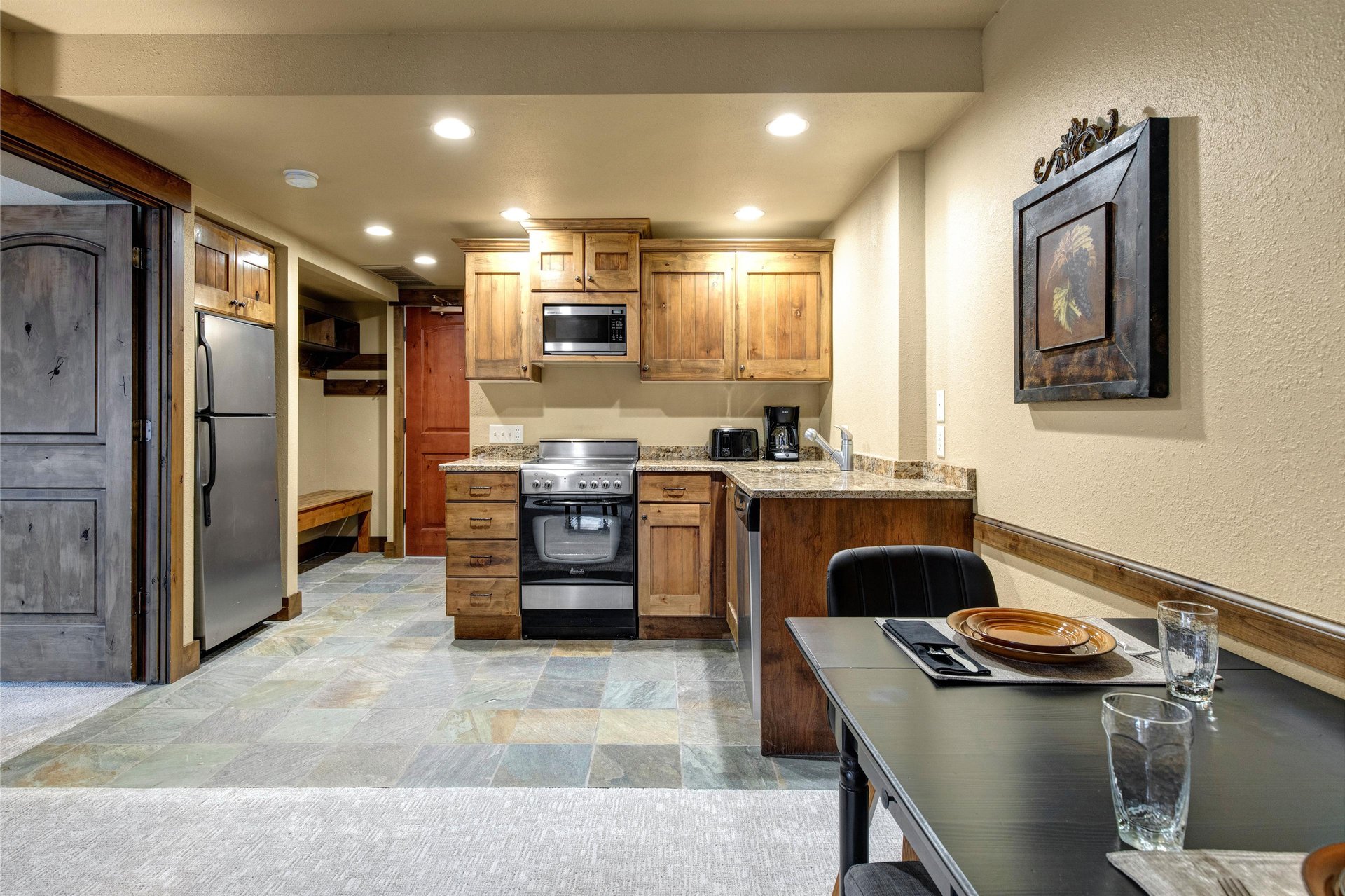 Your fully equipped kitchen with warm wood cabinets and granite counters.