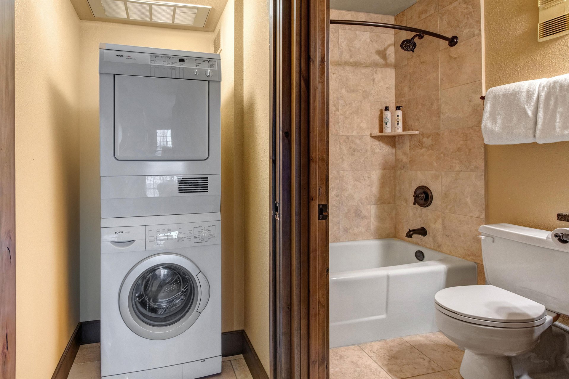 Your bathroom features a relaxing tubshower combo with warm stone tiles, while the convenient inunit washer and dryer.