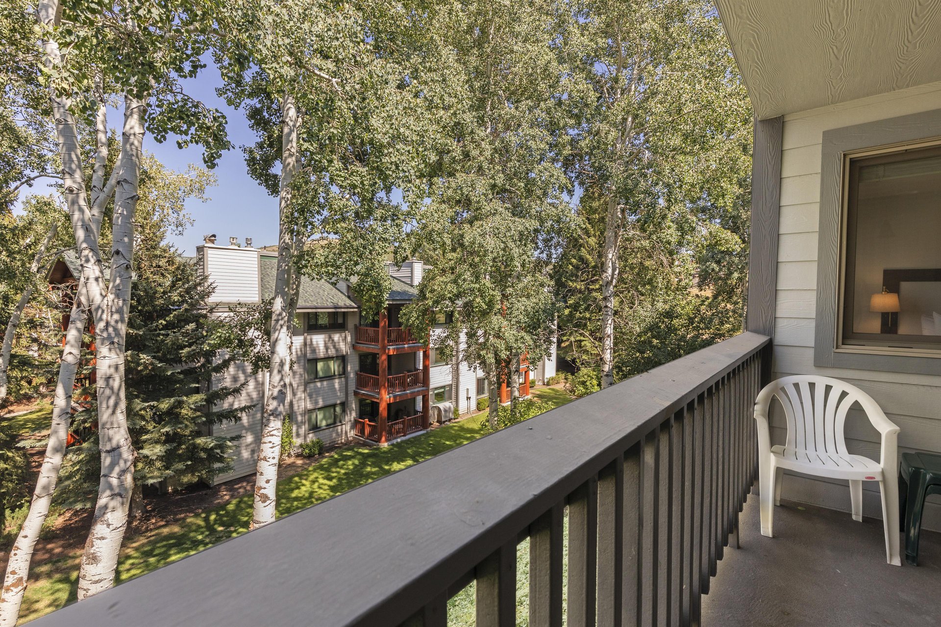 The private patio is surrounded by rustling aspens in the summer.
