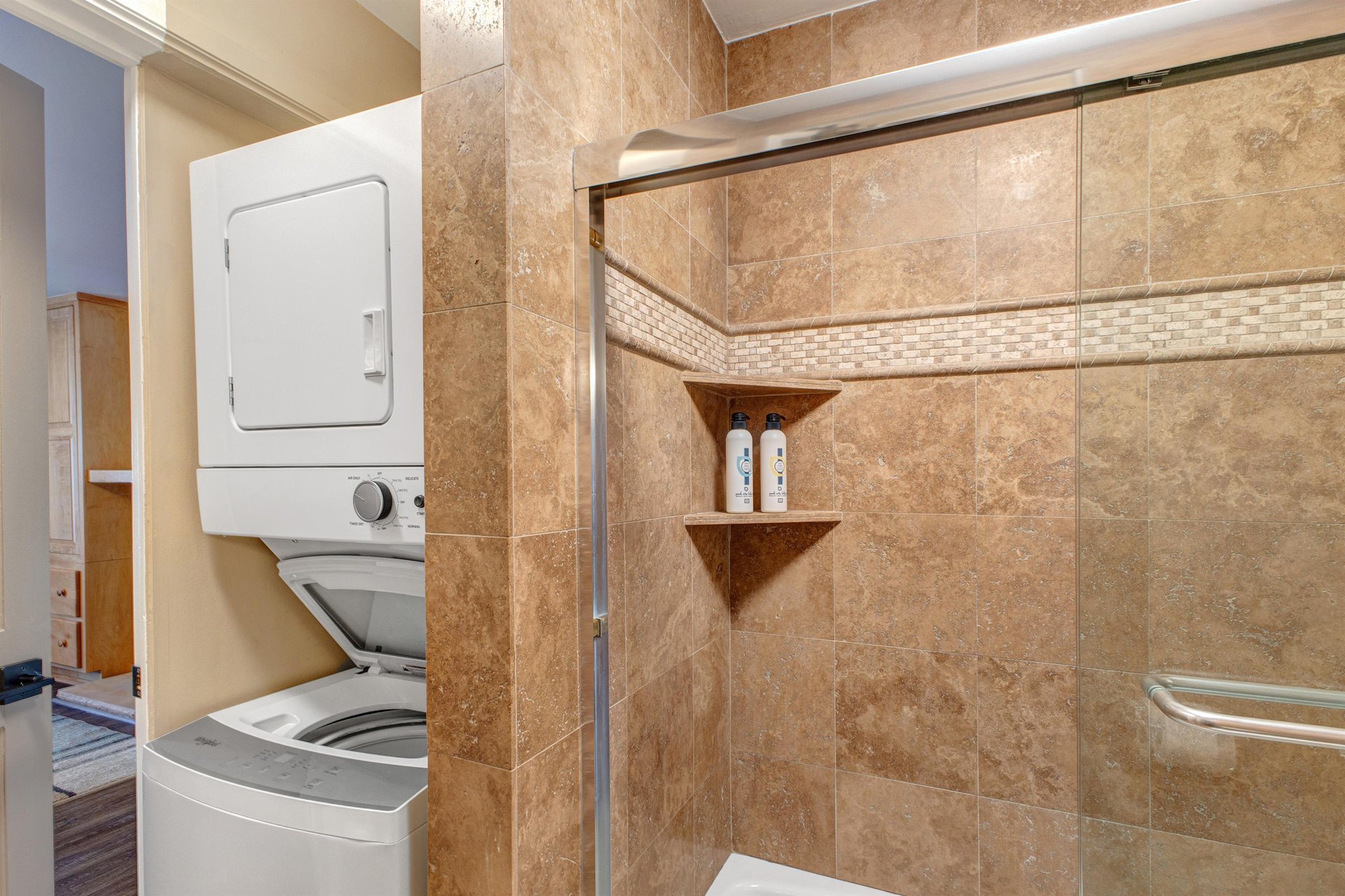 Resort Plaza 5024s shared bathroom with a stackable washer and dryer.