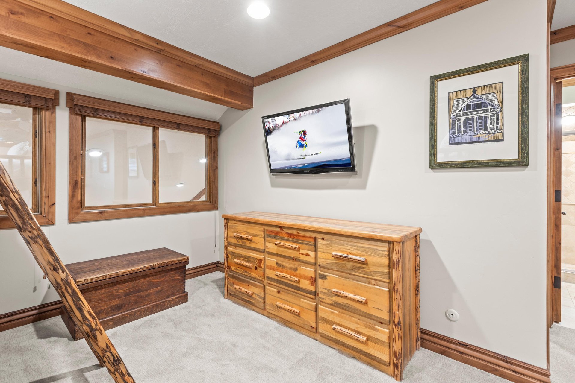 Your cozy retreat features rustic wood furnishings and a mounted TV for relaxing after mountain adventures.