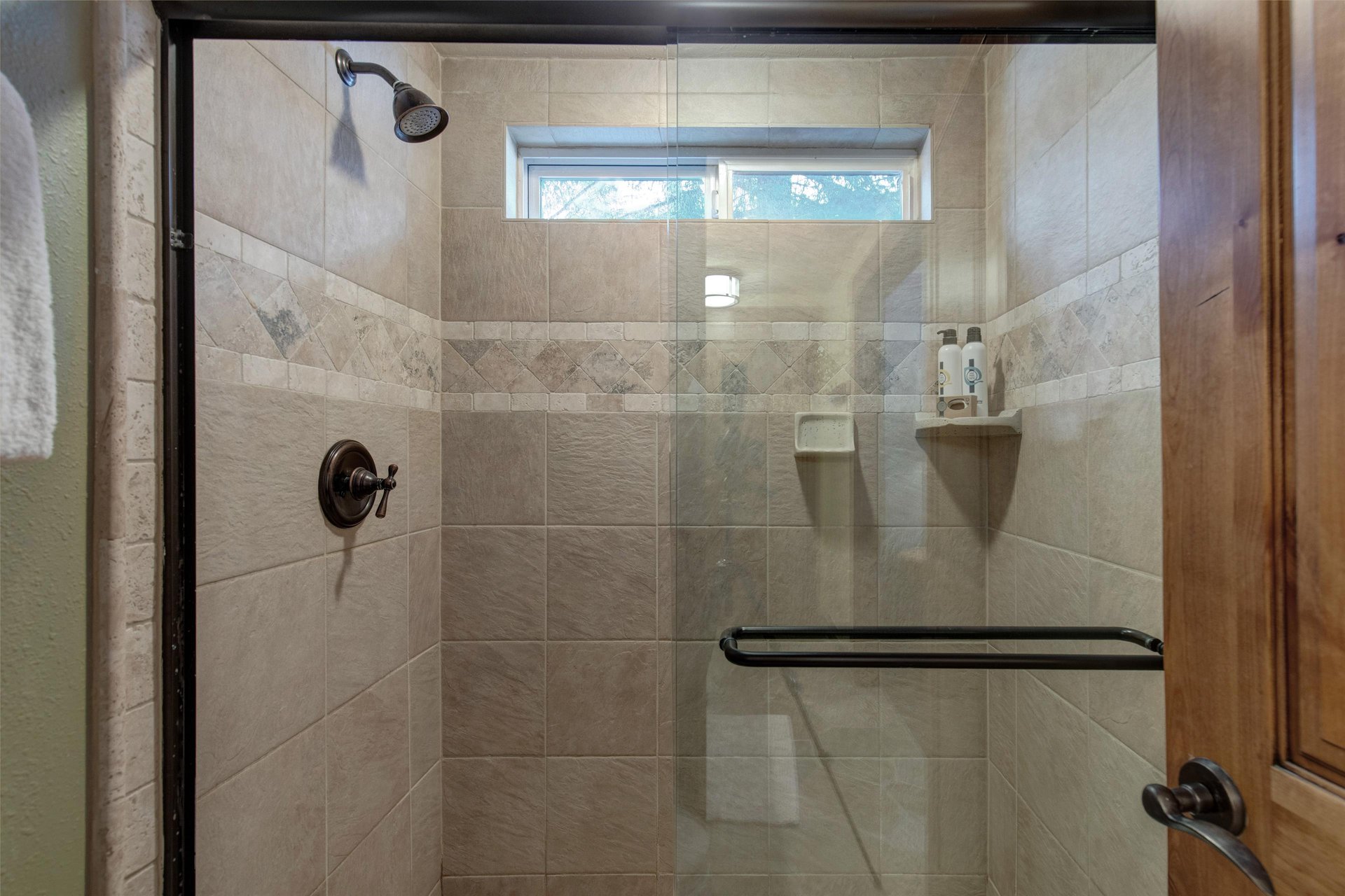 The en suite bathroom offers a walkin shower with sliding glass doors.