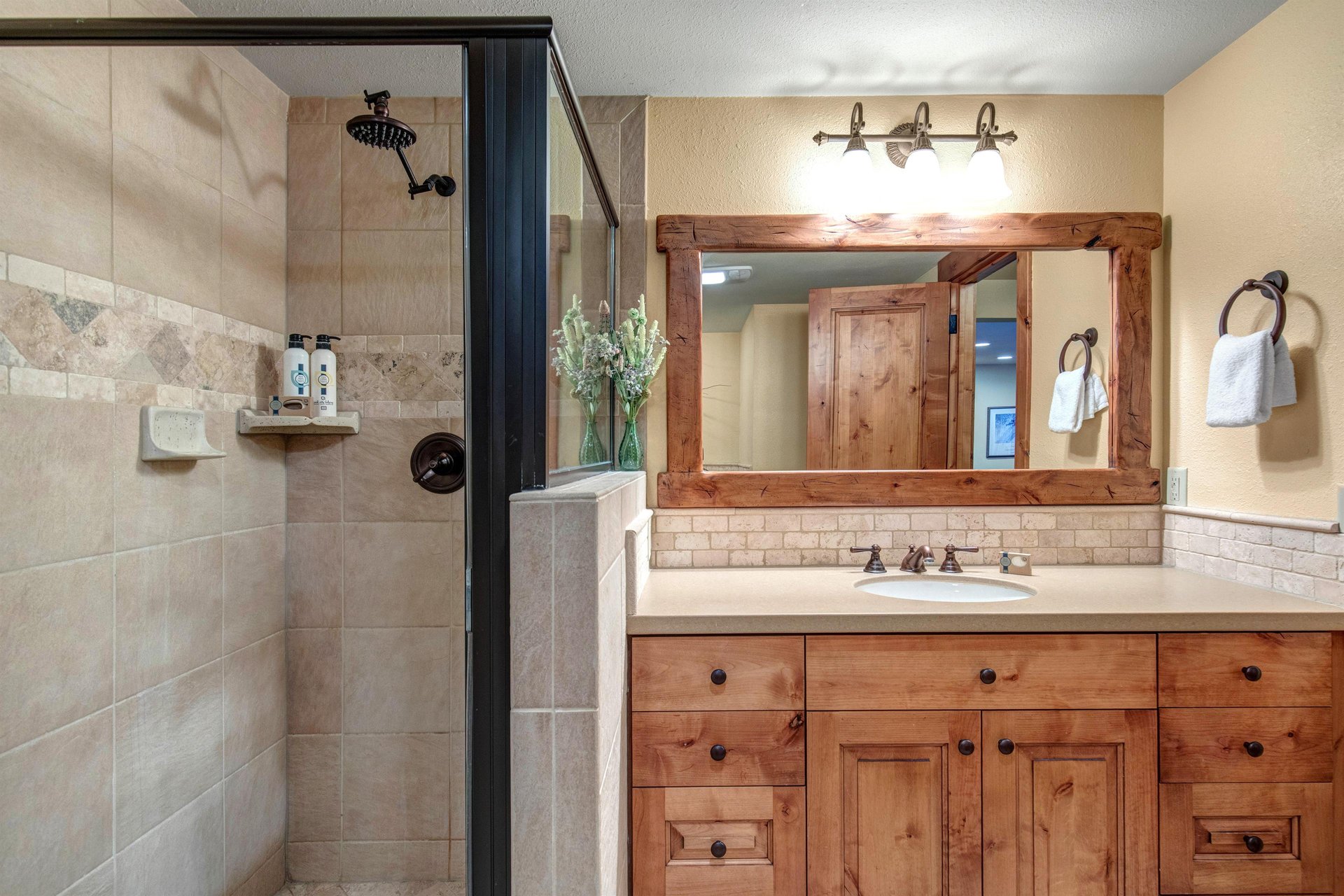 The shared bathroom offers a single sink vanity and walkin shower.