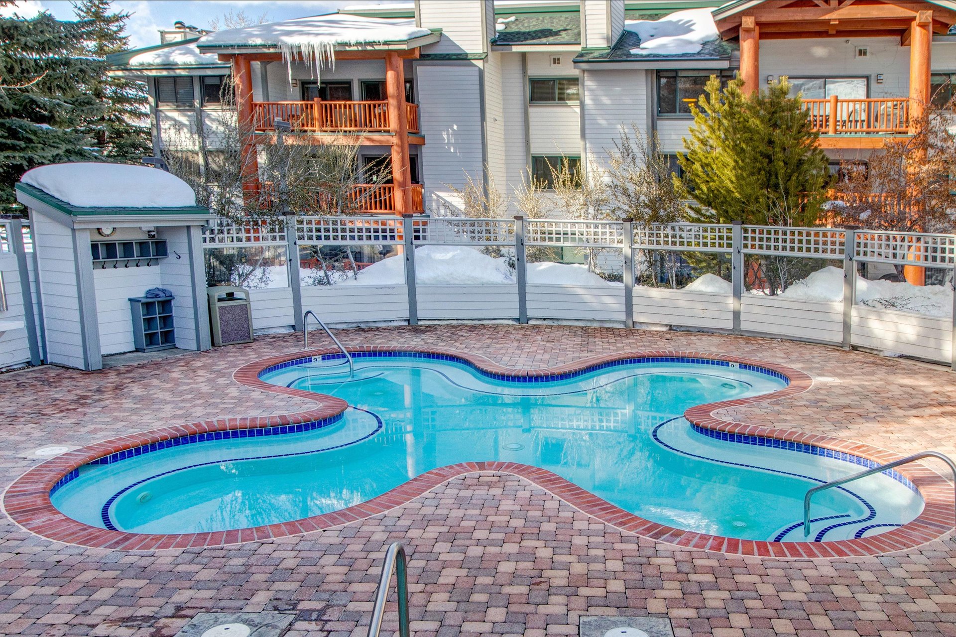Soak in the heated outdoor pool in the shape of a flower at Snow Flower Condominiums.