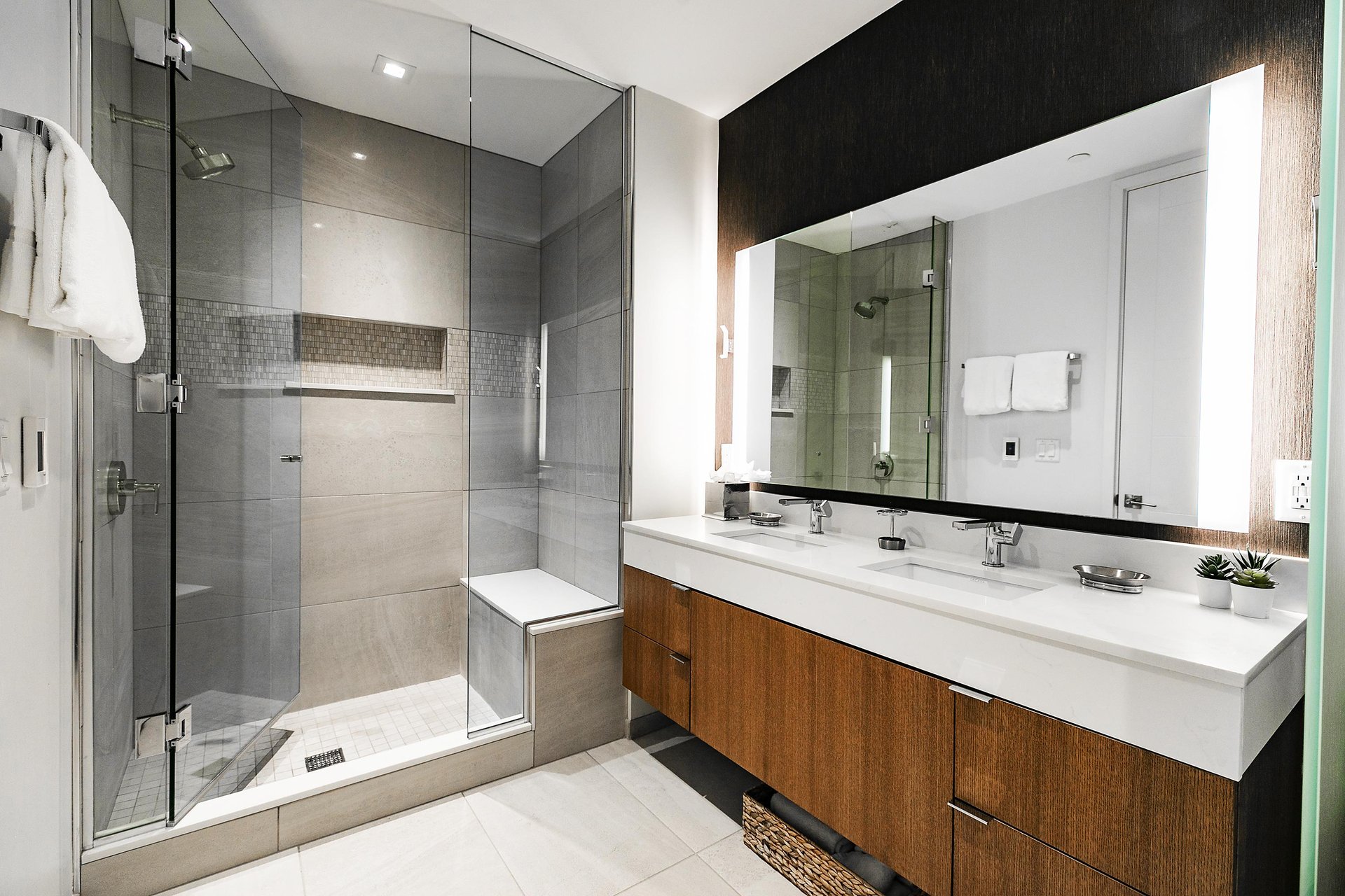 Dual vanity main bathroom, glass panel showere with tiled walls