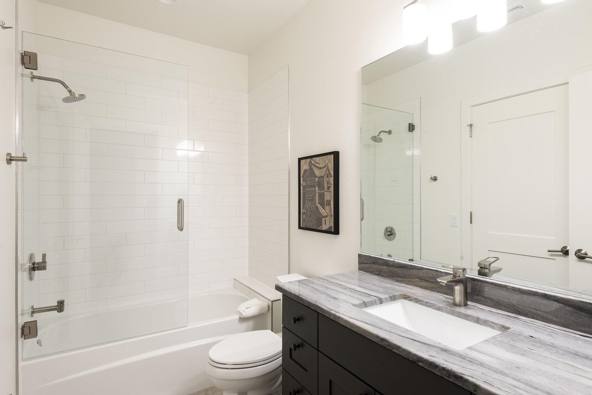 Full bathroom with step in shower and tub with tempered glass enclosure